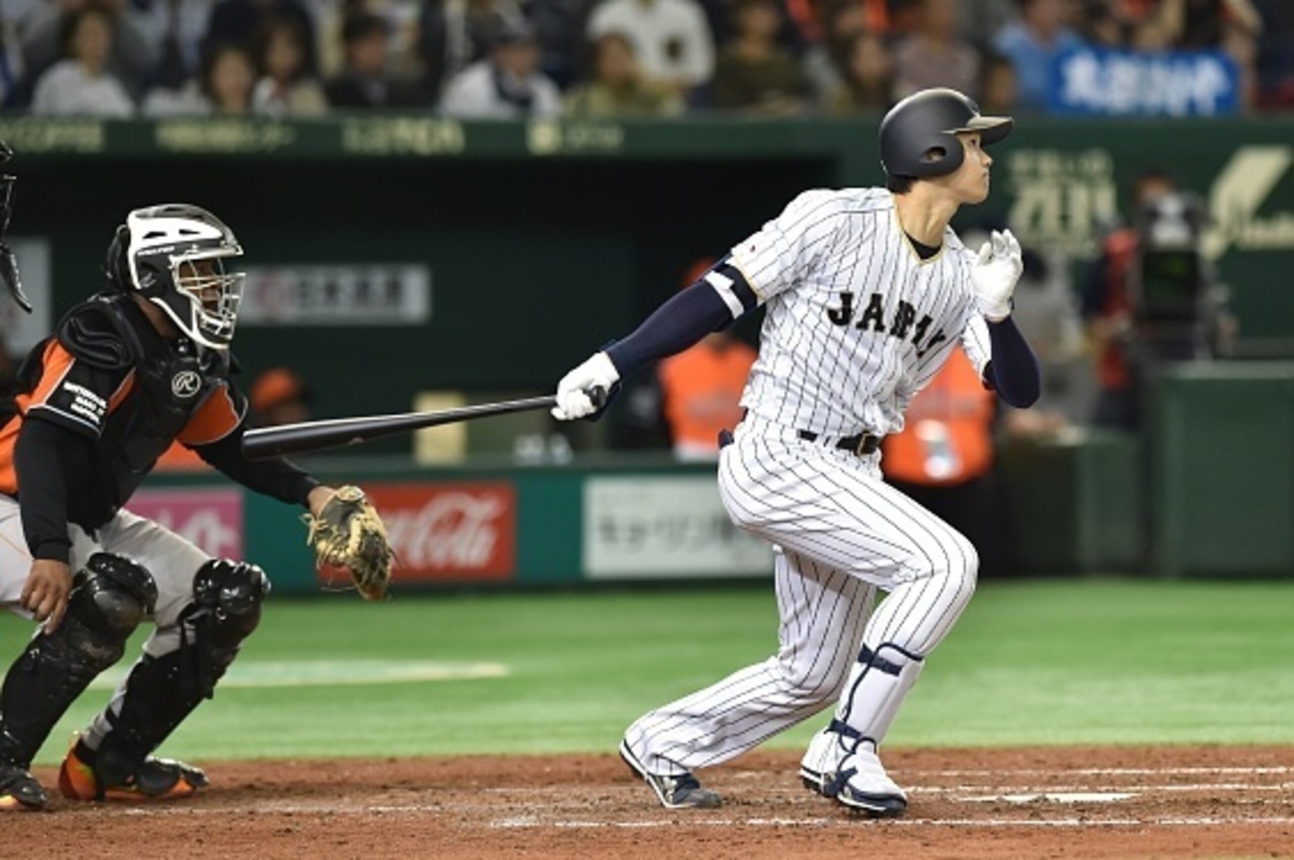 Designated hitter Shohei Ohtani of Japan follows his solo homer in the fifth inning during the international friendly baseball match between Japan and the Netherlands at the Tokyo Dome on November 12, 2016. / AFP / KAZUHIRO NOGI        (Photo credit shoul