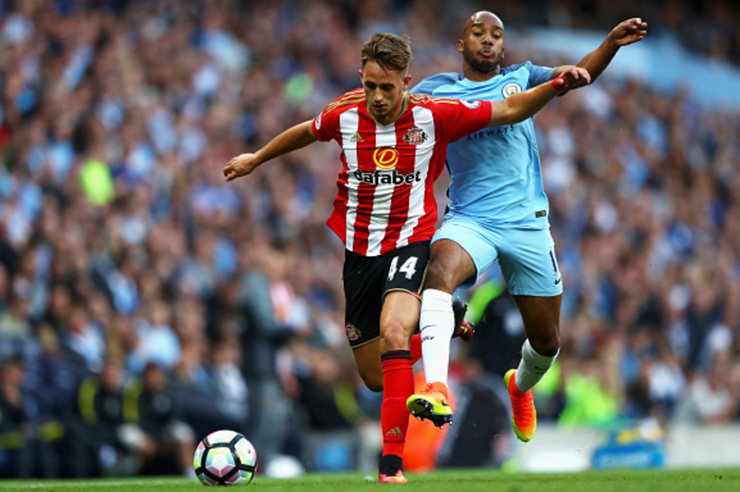 MANCHESTER, ENGLAND - AUGUST 13: Adnan Januzaj of Sunderland is challegned by Fabian Delph of Manchester City during the Premier League match between Manchester City and Sunderland at Etihad Stadium on August 13, 2016 in Manchester, England.  (Photo by Mi