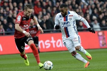Guingamp's French defender Lucas Deaux (L) vies with Lyon's French forward Alexandre Lacazette during the French Ligue 1 football match between Guingamp and Lyon on February 11, 2017 at the Roudourou stadium in Guingamp, western France. / AFP / FRED TANNE