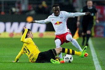 DORTMUND, GERMANY - FEBRUARY 04: Julian Weigl of Borussia Dortmund and Naby Deco Keita of RB Leipzig battle for the ball during the Bundesliga soccer match between Borussia Dortmund and RB Leipzig at the Signal Iduna Park in Dortmund, Germany on February 