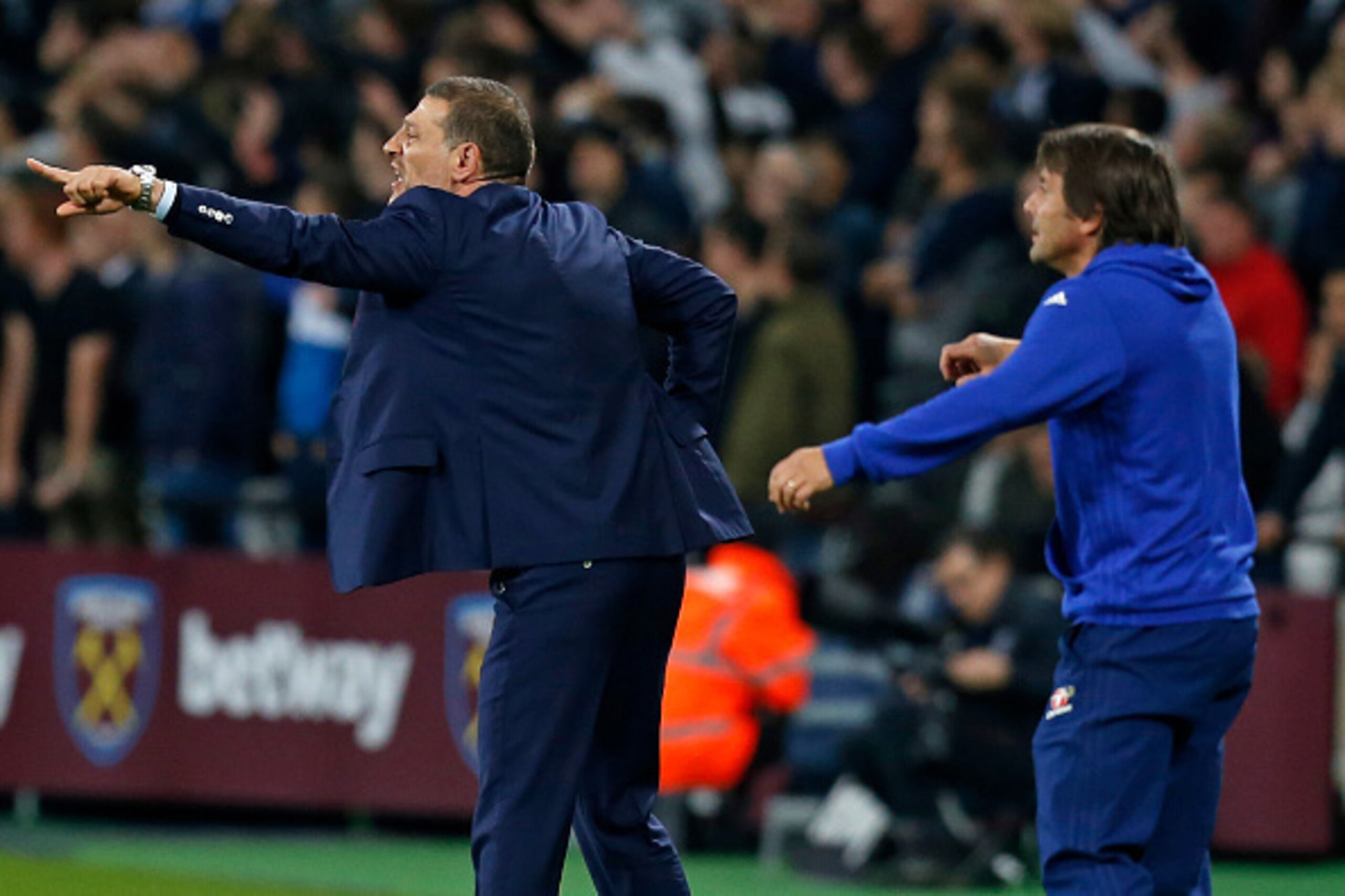West Ham United's Croatian manager Slaven Bilic (L) and Chelsea's Italian head coach Antonio Conte gesture on the touchline during the EFL (English Football League) Cup fourth round match between West Ham United and Chelsea at The London Stadium in east L