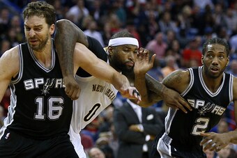 NEW ORLEANS, LA - MARCH 03: Pau Gasol #16 of the San Antonio Spurs, Kawhi Leonard #2 and DeMarcus Cousins #0 of the New Orleans Pelicans go for a rebound during the second half of a game at the Smoothie King Center on March 3, 2017 in New Orleans, Louisia