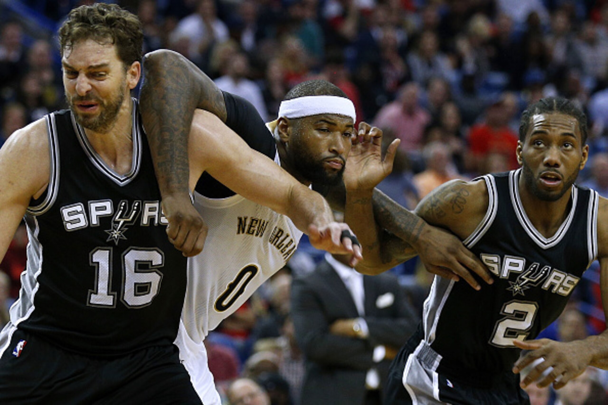 NEW ORLEANS, LA - MARCH 03: Pau Gasol #16 of the San Antonio Spurs, Kawhi Leonard #2 and DeMarcus Cousins #0 of the New Orleans Pelicans go for a rebound during the second half of a game at the Smoothie King Center on March 3, 2017 in New Orleans, Louisia