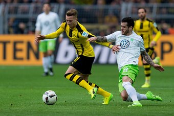DORTMUND, GERMANY - FEBRUARY 18: Marco Reus of Dortmund and Vieirinha Da Freitas of Wolfsburg battle for the ball during the Bundesliga match between Borussia Dortmund and VfL Wolfsburg at Signal Iduna Park on February 18, 2017 in Dortmund, Germany. (Phot