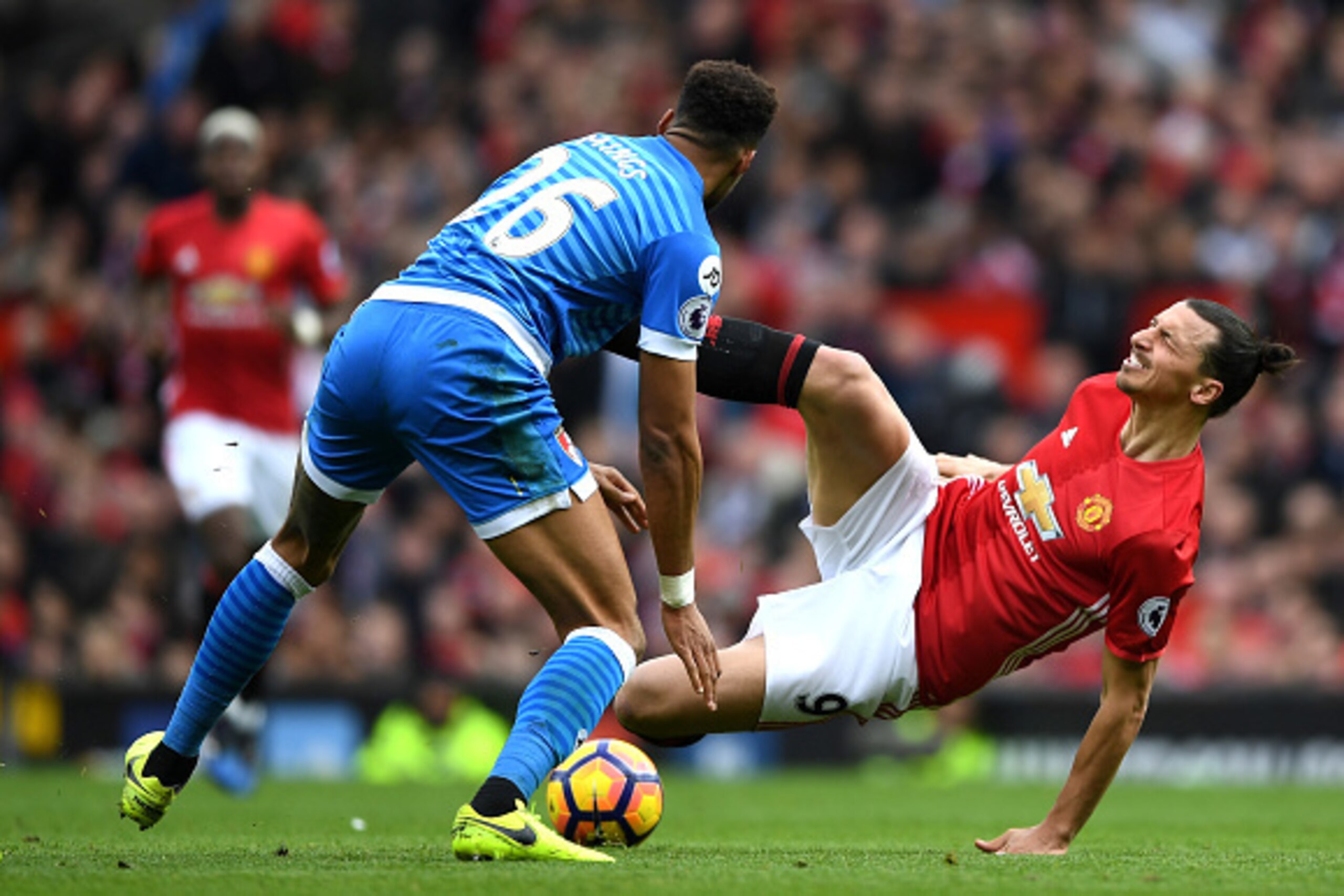 MANCHESTER, ENGLAND - MARCH 04:  Zlatan Ibrahimovic of Manchester United (R) is challenged by Tyrone Mings of AFC Bournemouth (L) during the Premier League match between Manchester United and AFC Bournemouth at Old Trafford on March 4, 2017 in Manchester,