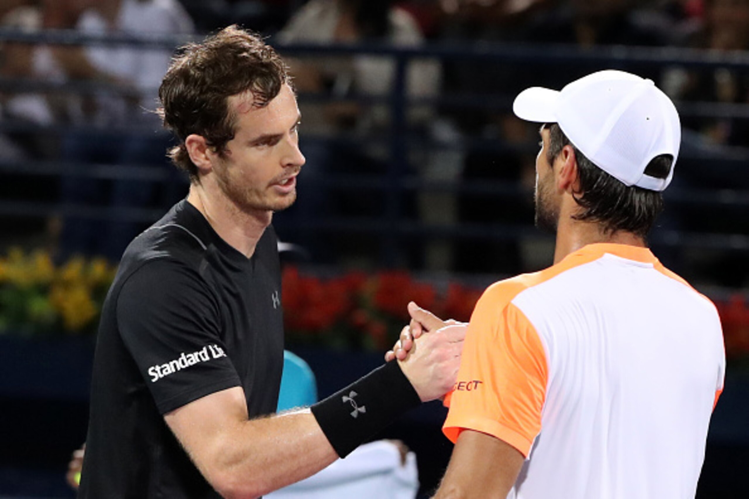 World number one Andy Murray (L) of Great Britain embraces Spain's Fernando Verdasco following their ATP final tennis match which Murray won, concluding the Dubai Duty Free Championships on March 4, 2017.
Murray clinched his first title of 2017 and 45th o