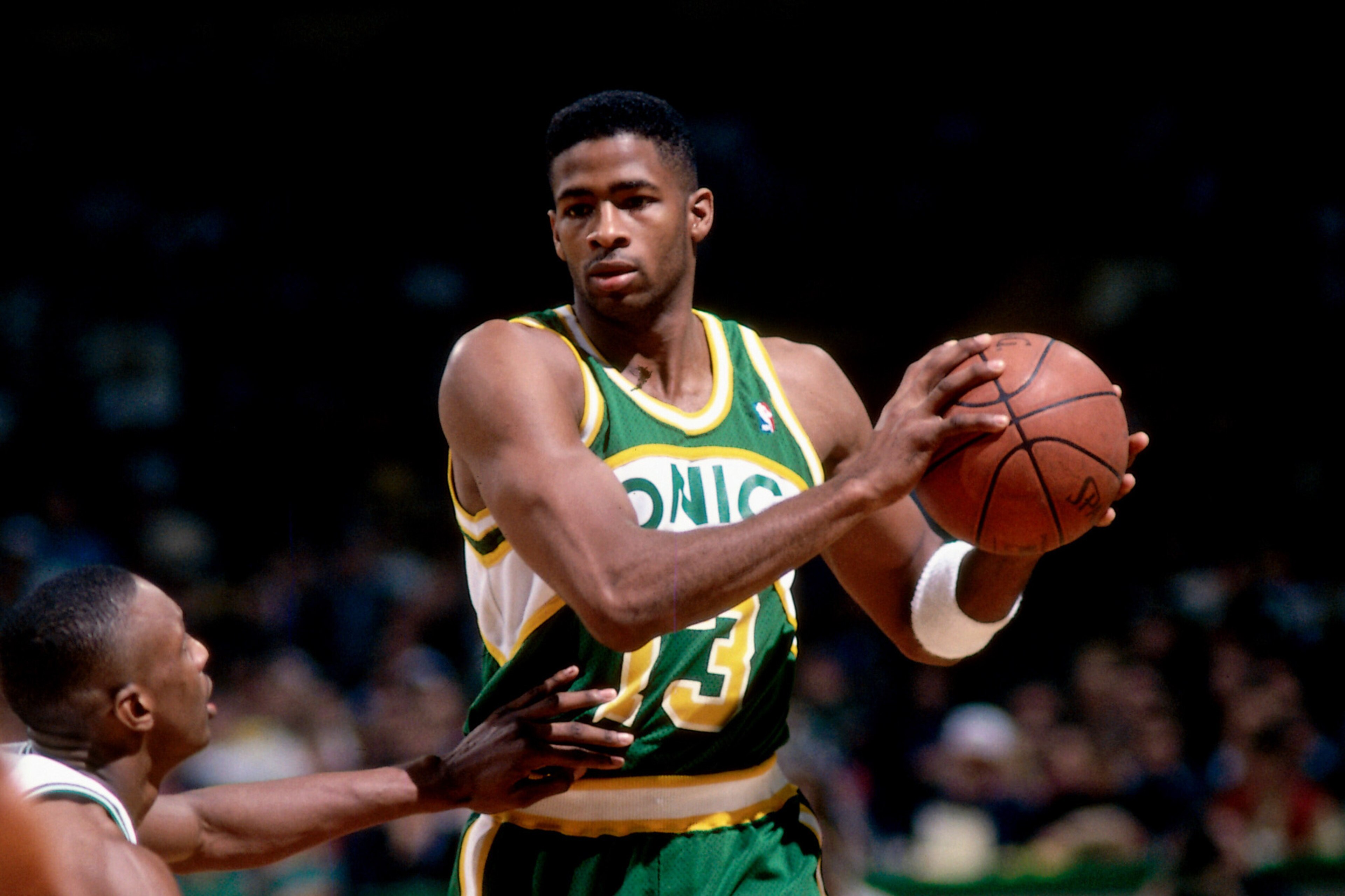 BOSTON, MA - 1994: Kendall Gill #13 of the Seattle SuperSonics looks to pass against Dee Brown #7 of the Boston Celtics during a game played circa 1994 at the Boston Garden in Boston, Massachusetts. NOTE TO USER: User expressly acknowledges and agrees tha