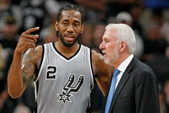 SAN ANTONIO,TX - MARCH 12: Kawhi Leonard #2 of the San Antonio Spurs talks with head coach Gregg Popovich at AT&T Center on March 12, 2016 in San Antonio, Texas.  NOTE TO USER: User expressly acknowledges and agrees that , by downloading and or using this