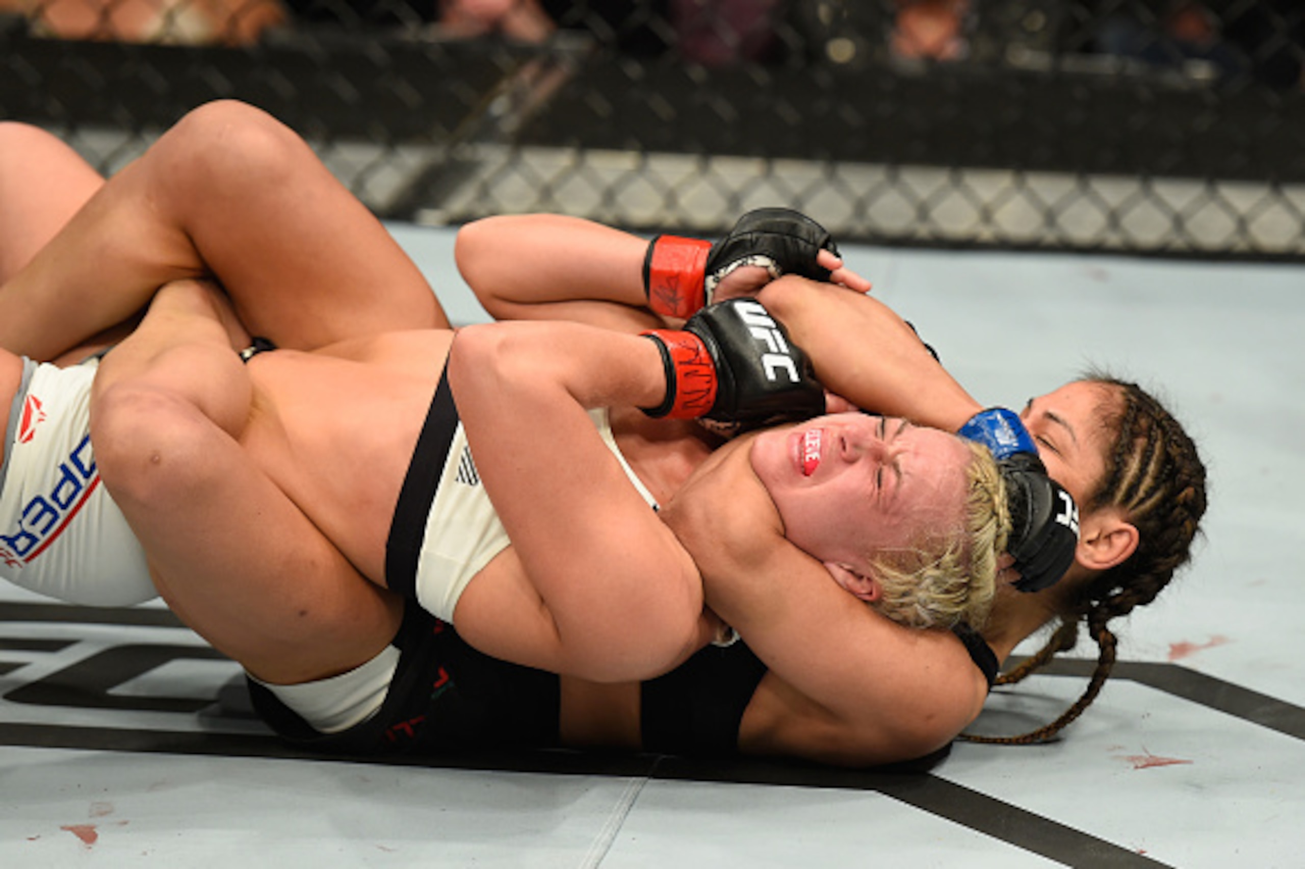 LAS VEGAS, NV - MARCH 04:  Cynthia Calvillo (black) attempts to submit Amanda Cooper in their women's strawweight bout during the UFC 209 event at T-Mobile Arena on March 4, 2017 in Las Vegas, Nevada.  (Photo by Josh Hedges/Zuffa LLC/Zuffa LLC via Getty I