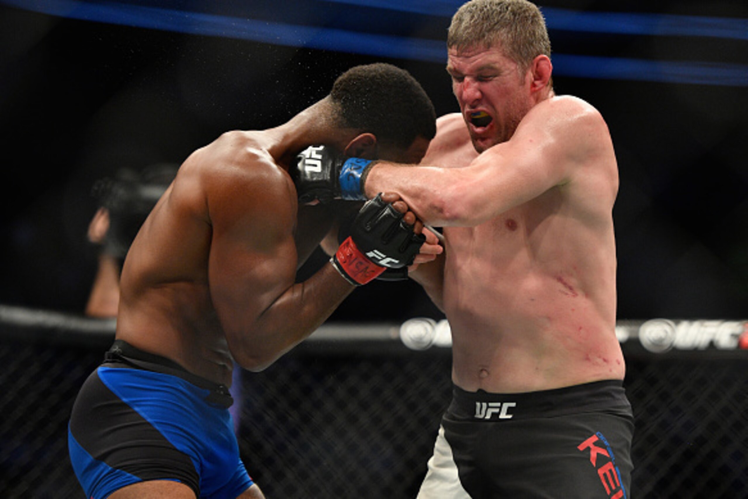 LAS VEGAS, NV - MARCH 04: (R-L) Daniel Kelly of Australia punches Rashad Evans in their middleweight bout during the UFC 209 event at T-Mobile Arena on March 4, 2017 in Las Vegas, Nevada.  (Photo by Jeff Bottari/Zuffa LLC/Zuffa LLC via Getty Images)
