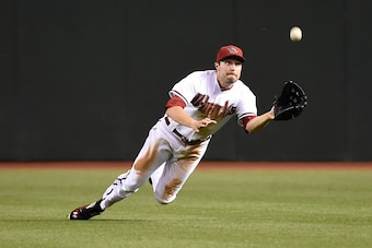 PHOENIX, AZ - APRIL 28:  A.J. Pollock #11 of the Arizona Diamondbacks attempts to make a diving catch against the Colorado Rockies at Chase Field on April 28, 2015 in Phoenix, Arizona.  (Photo by Norm Hall/Getty Images)