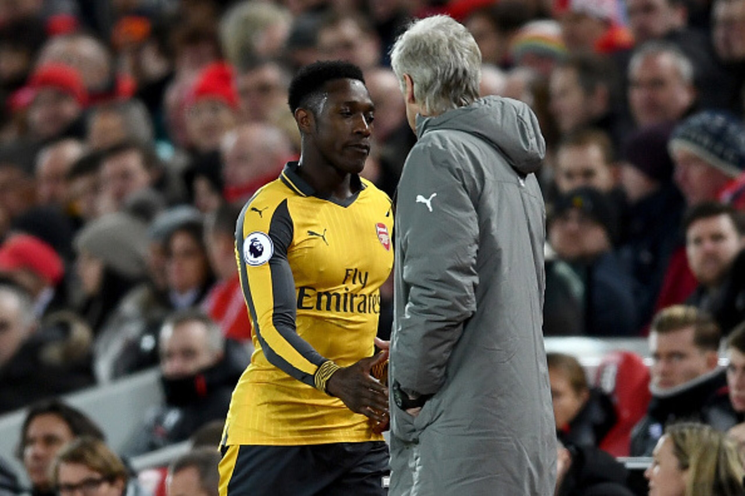 LIVERPOOL, ENGLAND - MARCH 04: Danny Welbeck of Arsenal (L) and Arsene Wenger, Manager of Arsenal (R) shake hands after Welbeck is subbed off during the Premier League match between Liverpool and Arsenal at Anfield on March 4, 2017 in Liverpool, England. 
