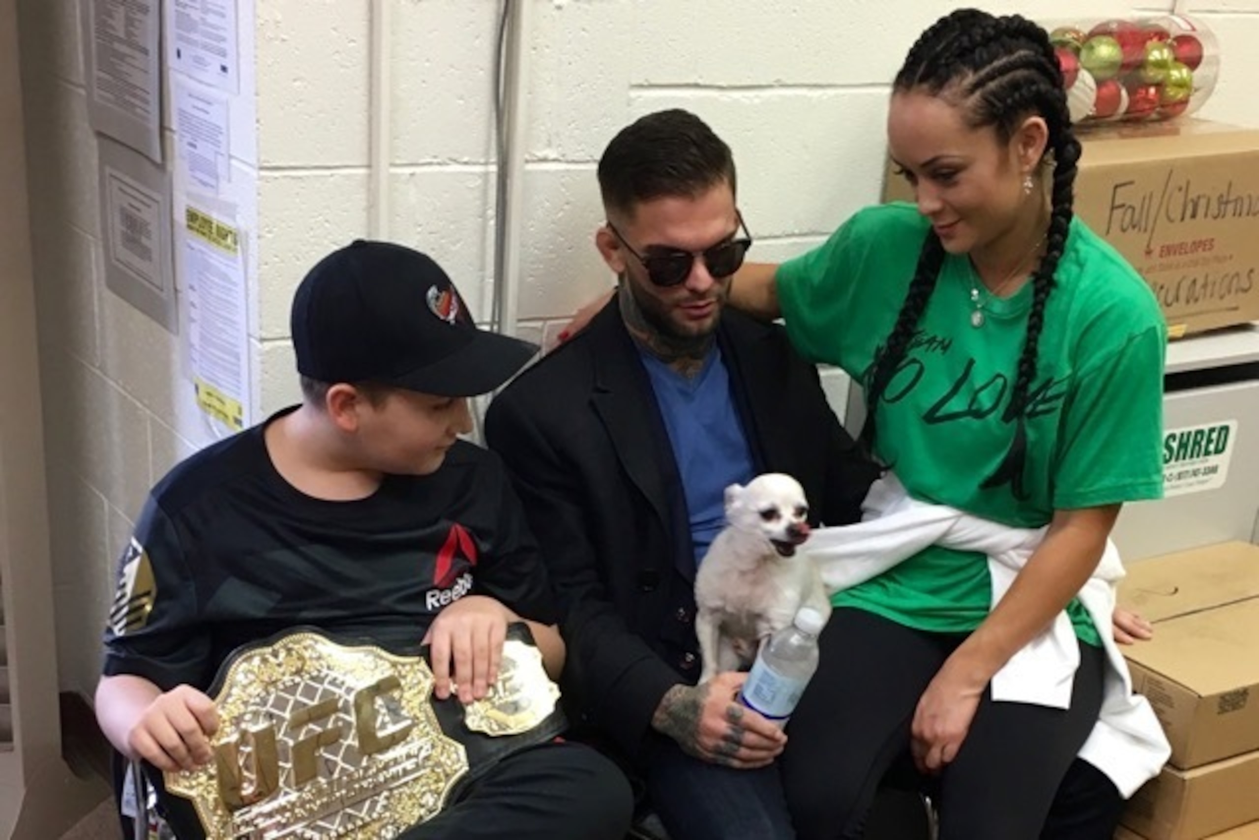 Cody Garbrandt (center) rests in the Claymont High School administrative office while waiting for his hometown's celebratory parade to start on January 22, 2017, along with his girlfriend Danny Pimsanguan (right)—and her Chihuahua, Casey, and Maddux Maple (left). Cody Garbrandt (center) rests in the Claymont High School administrative office while waiting for his hometown's celebratory parade to start on January 22, 2017, along with his girlfriend Danny Pimsanguan (right)—and her Chihuahua, Casey, and Maddux Maple (left).