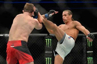 Urijah Faber kicks Brad Pickett in their bantamweight bout during the UFC Fight Night event inside the Golden 1 Center on December 17, 2016, in Sacramento, California.