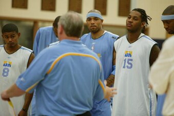 DENVER - OCTOBER 12: Earl Watson, Kenyon Martin and Carmelo Anthony of the Denver Nuggets listen to head coach George Karl before practice at the Pepsi Center on October 12, 2005 in Denver, Colorado.   NBA TV visited camp to shoot the team's practice for 