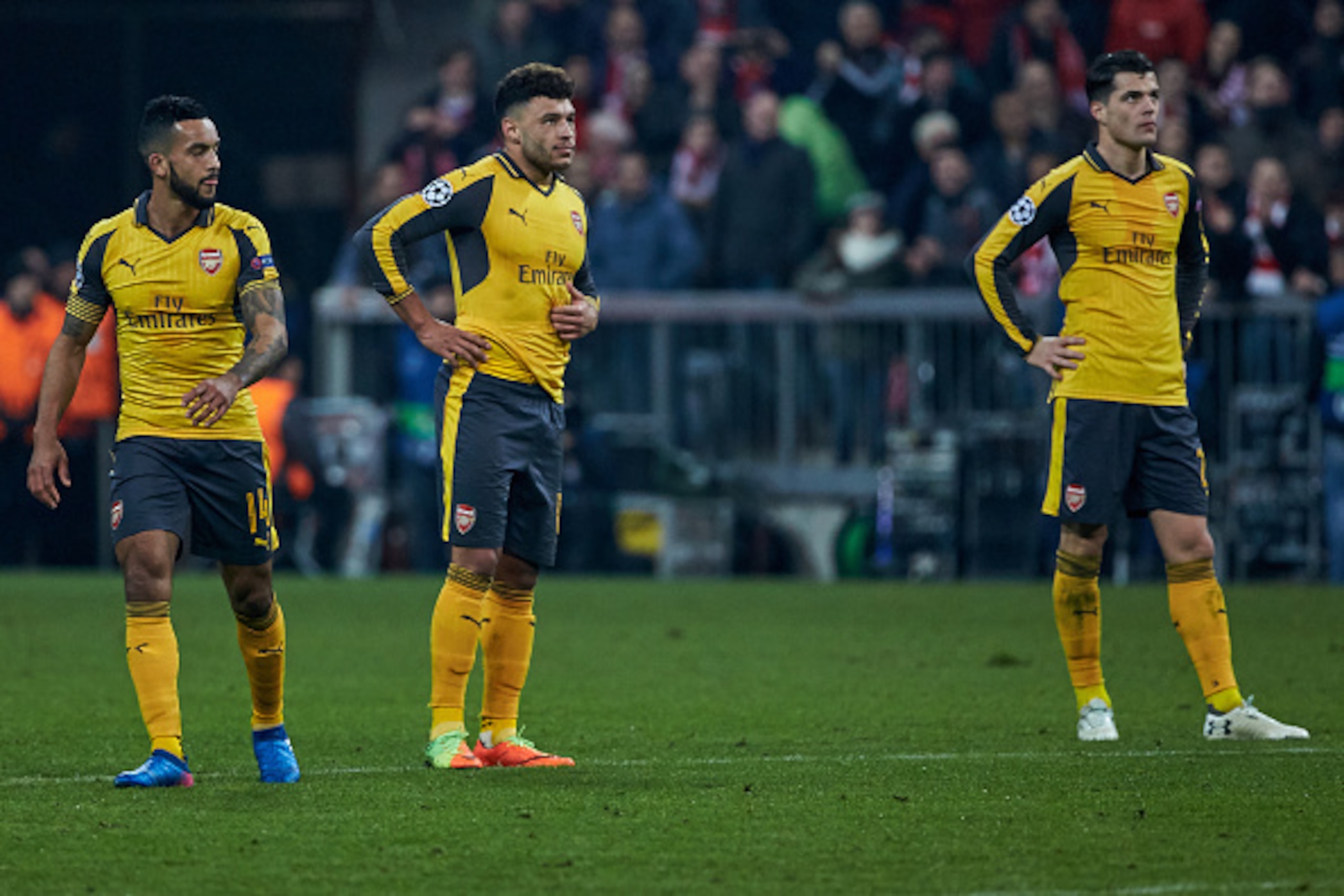 Munich, GERMANY - FEBRUARY 15: Theo Walcott of Arsenal , Alex Oxlade-Chamberlain of Arsenal and Granit Xhaka of Arsenal disappointed during the UEFA Champions League Round of 16 first leg match between FC Bayern Muenchen and Arsenal FC at Allianz Arena on