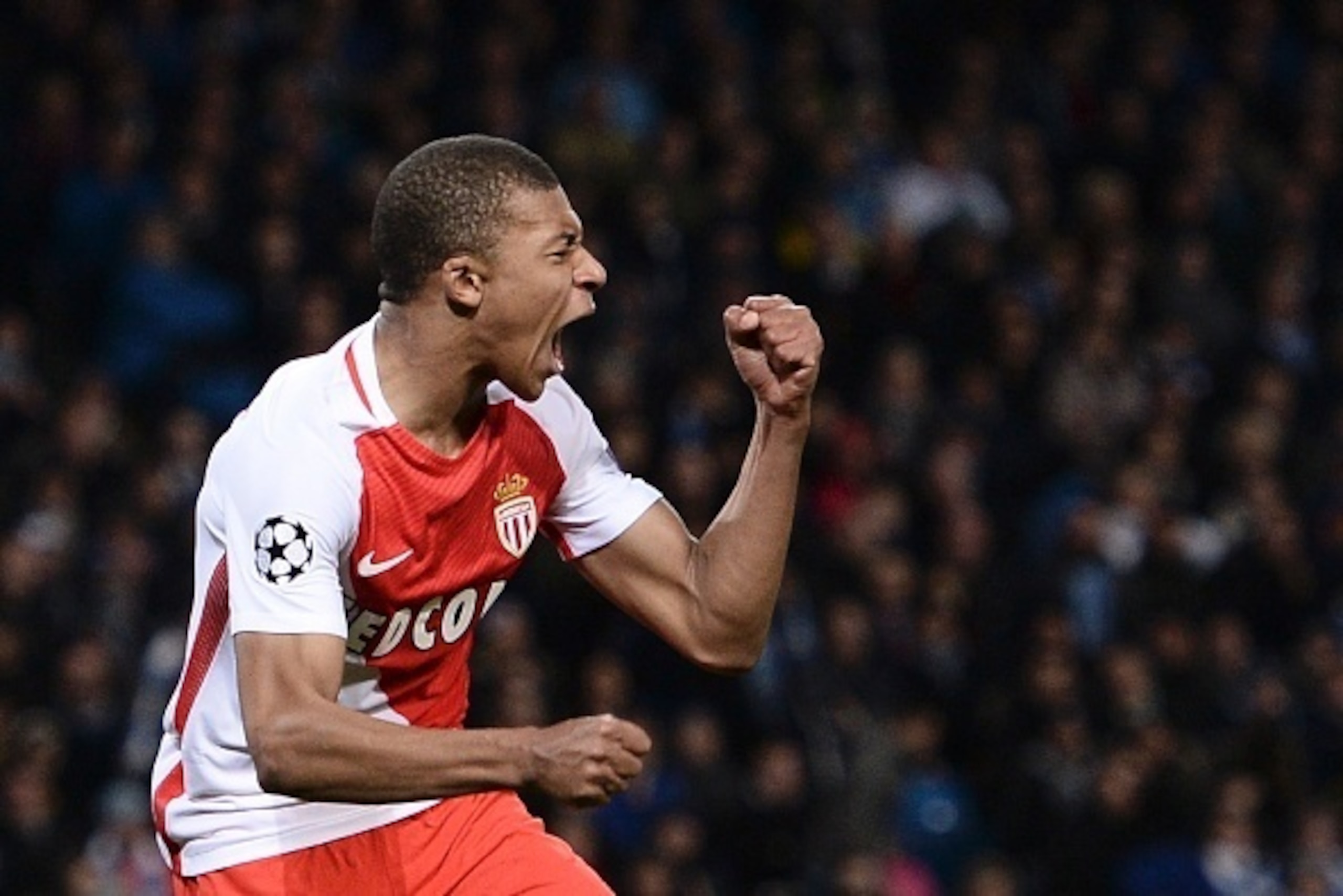 Monaco's French forward Kylian Mbappe Lottin celebrates scoring their second goal woth Monaco's French defender Benjamin Mendy during the UEFA Champions League Round of 16 first-leg football match between Manchester City and Monaco at the Etihad Stadium i