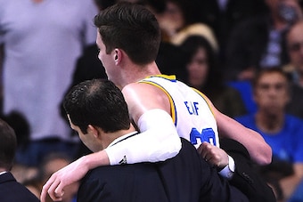 LOS ANGELES, CA - MARCH 1:  TJ Leaf #22 of the UCLA Bruins is helped off the court after he was injured in the first half of the game against the Washington Huskies at Pauley Pavilion on March 1, 2017 in Los Angeles, California. (Photo by Jayne Kamin-Once
