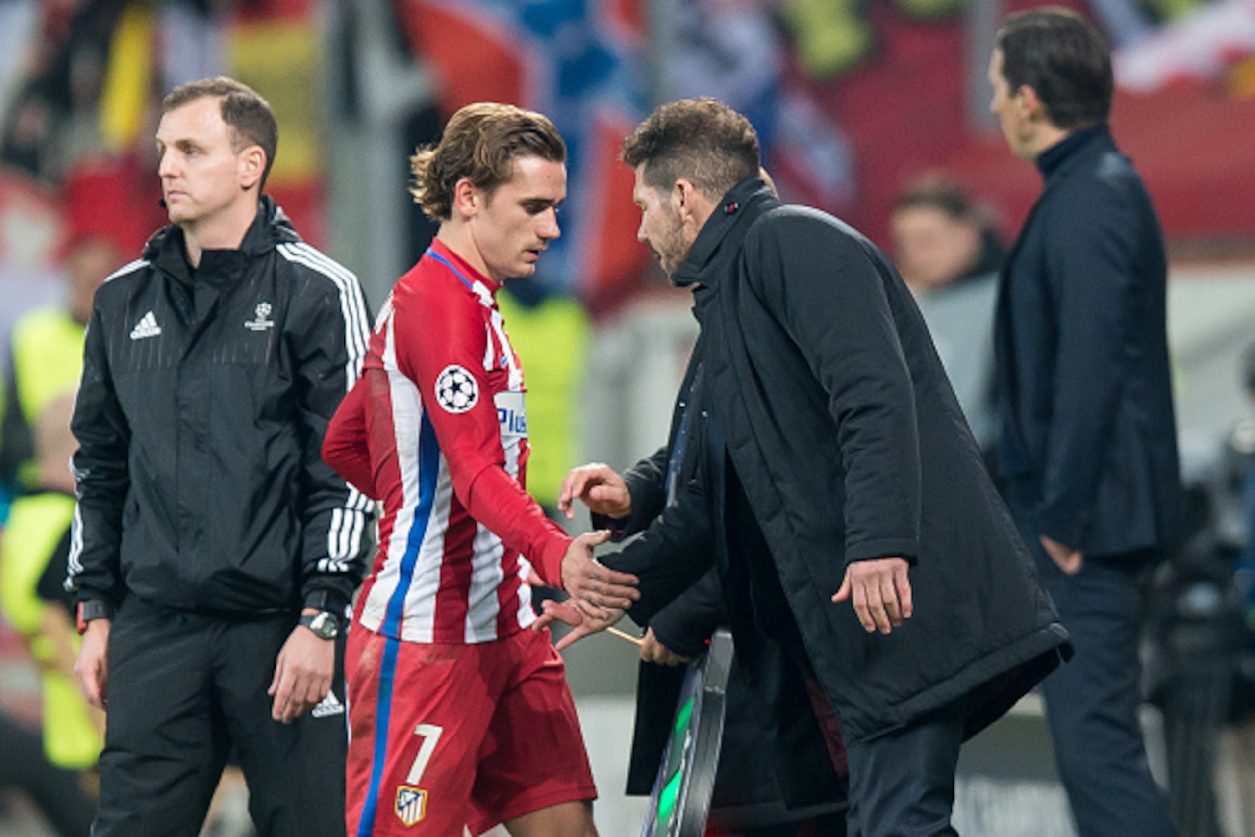 LEVERKUSEN, GERMANY - FEBRUARY 21: Antoine Griezmann of Atletico Madrid shakes hands with Head coach Diego Simeone of Atletico Madrid during the UEFA Champions League Round of 16 first leg match between Bayer Leverkusen and Club Atletico de Madrid at BayA