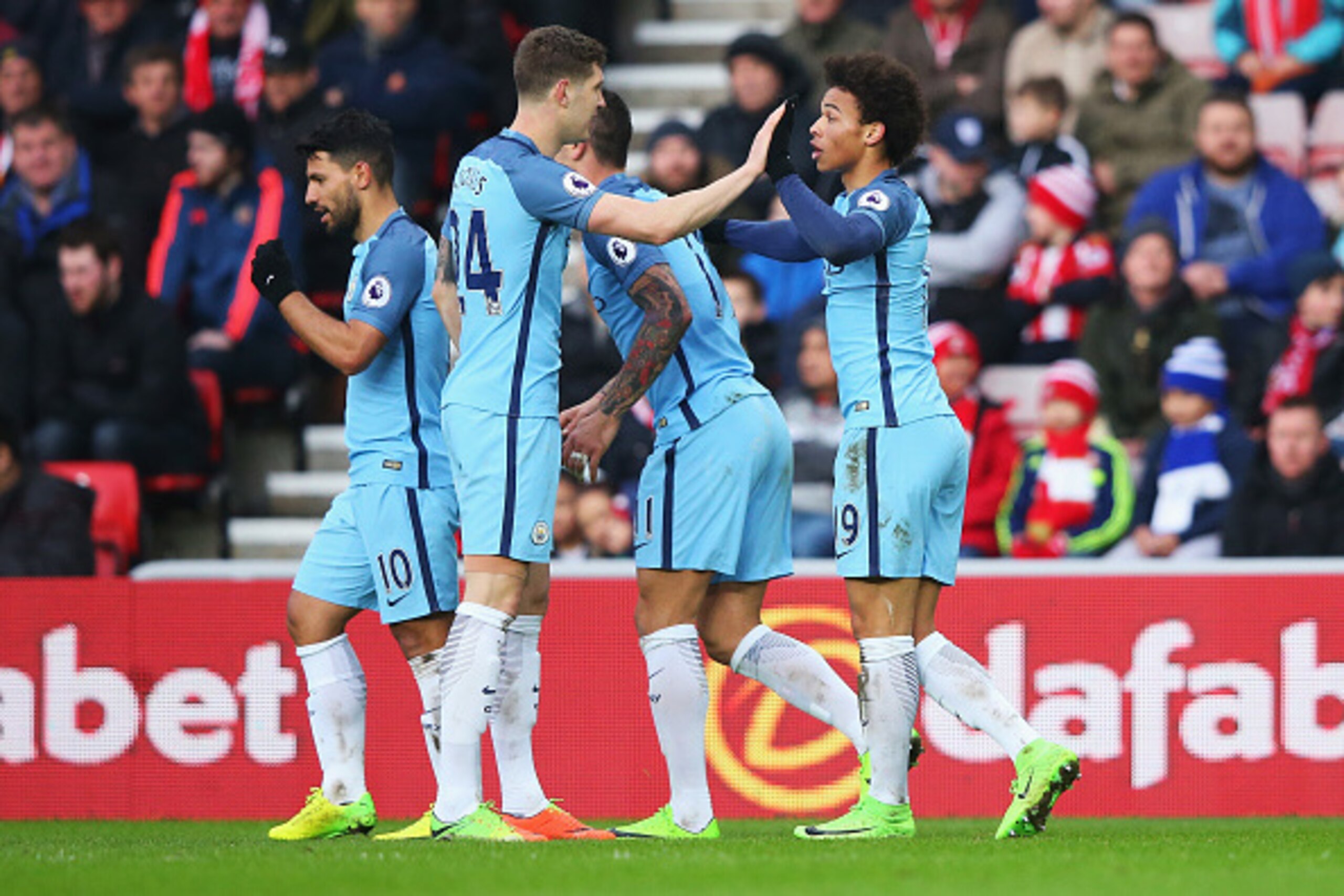 SUNDERLAND, ENGLAND - MARCH 05: Leroy Sane of Manchester City (R) celebrates scoring his sides second goal with John Stones of Manchester City (L) during the Premier League match between Sunderland and Manchester City at Stadium of Light on March 5, 2017 