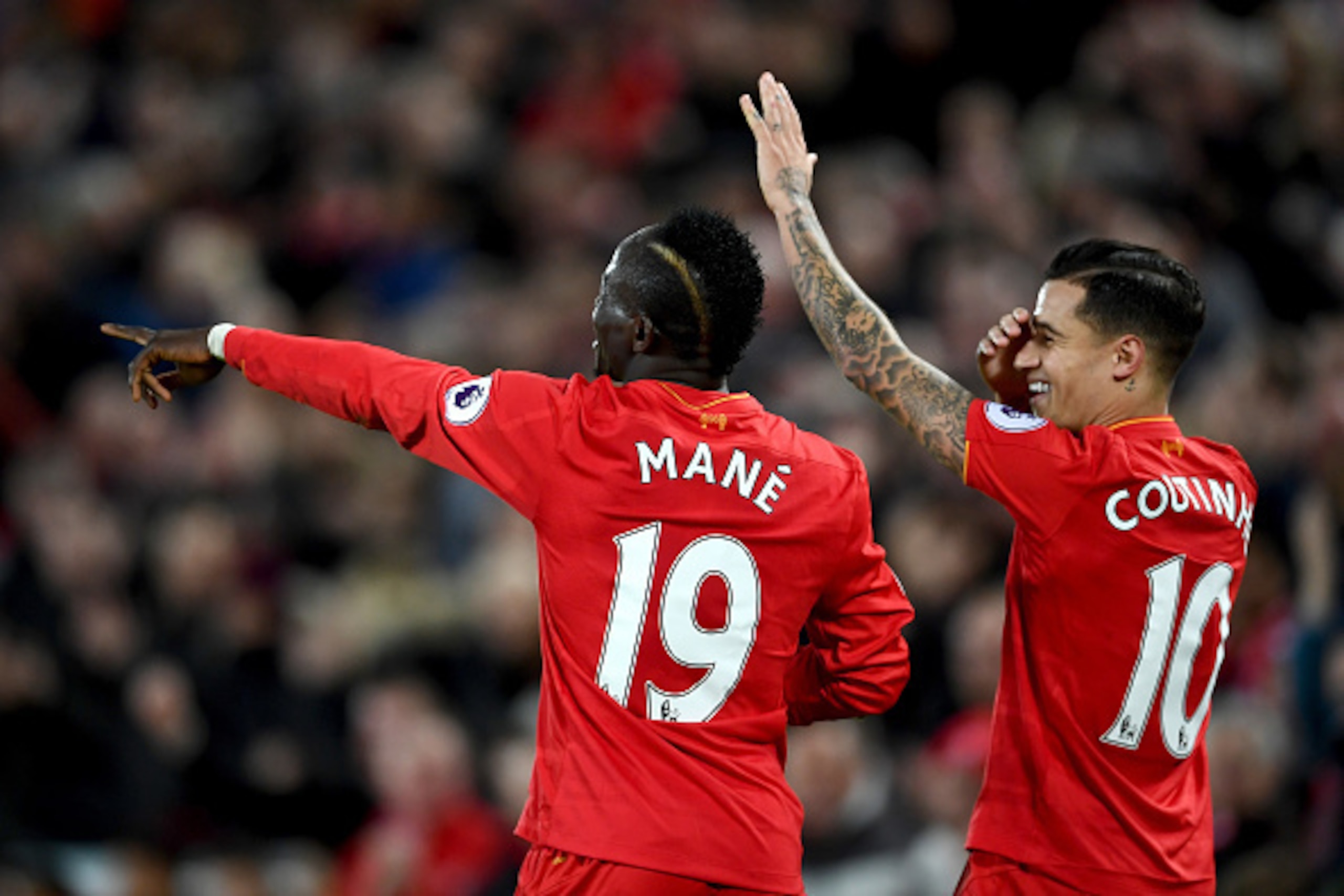 LIVERPOOL, ENGLAND - MARCH 04: Sadio Mane of Liverpool (L) celebrates scoring his sides second goal with Philippe Coutinho of Liverpool (R) during the Premier League match between Liverpool and Arsenal at Anfield on March 4, 2017 in Liverpool, England.  (