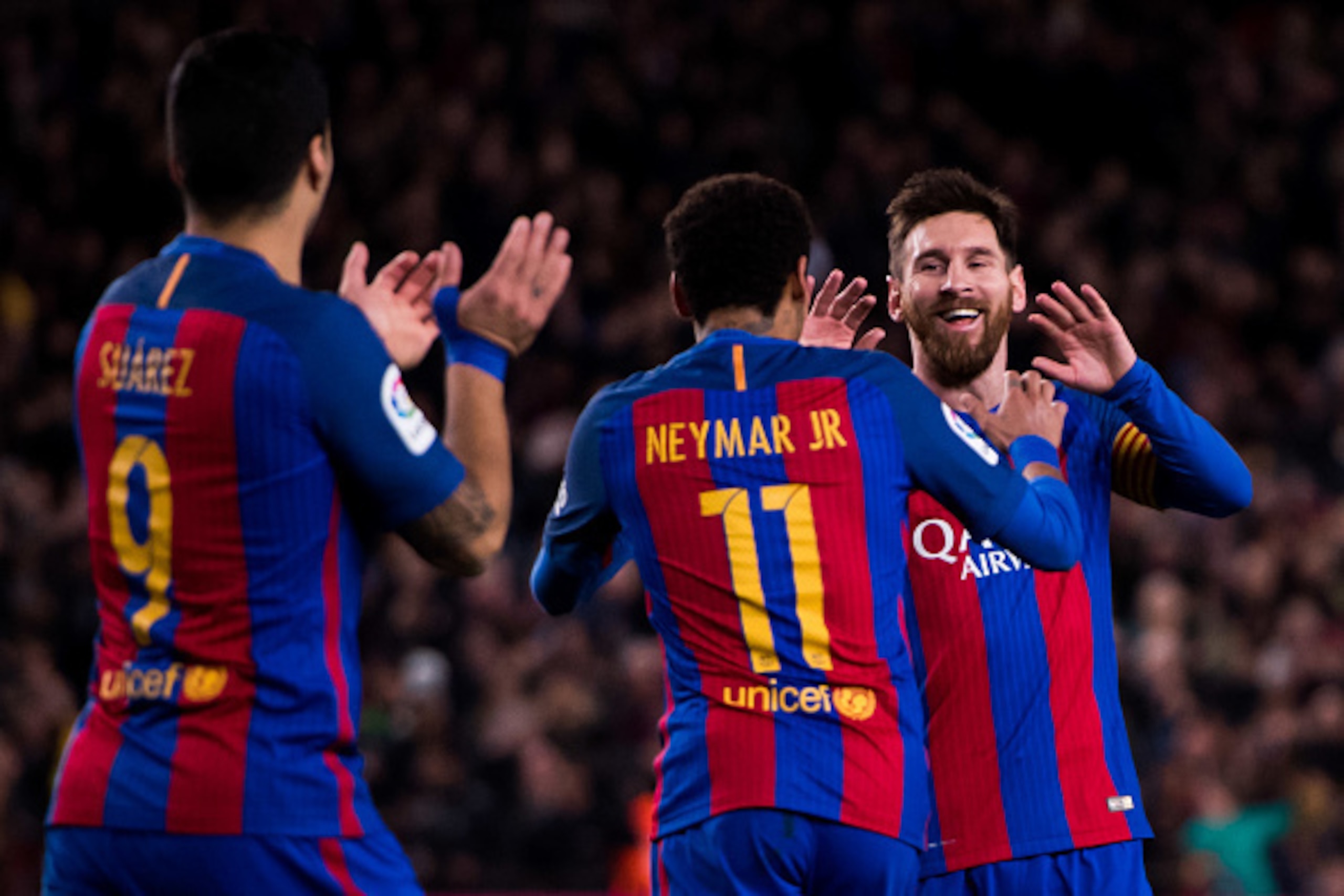 BARCELONA, SPAIN - MARCH 04: Lionel Messi (R) of FC Barcelona celebrates with his teammates Neymar Santos Jr (C) and Luis Suarez (L) after scoring his team's fifth goal during the La Liga match between FC Barcelona and RC Celta de Vigo at Camp Nou stadium
