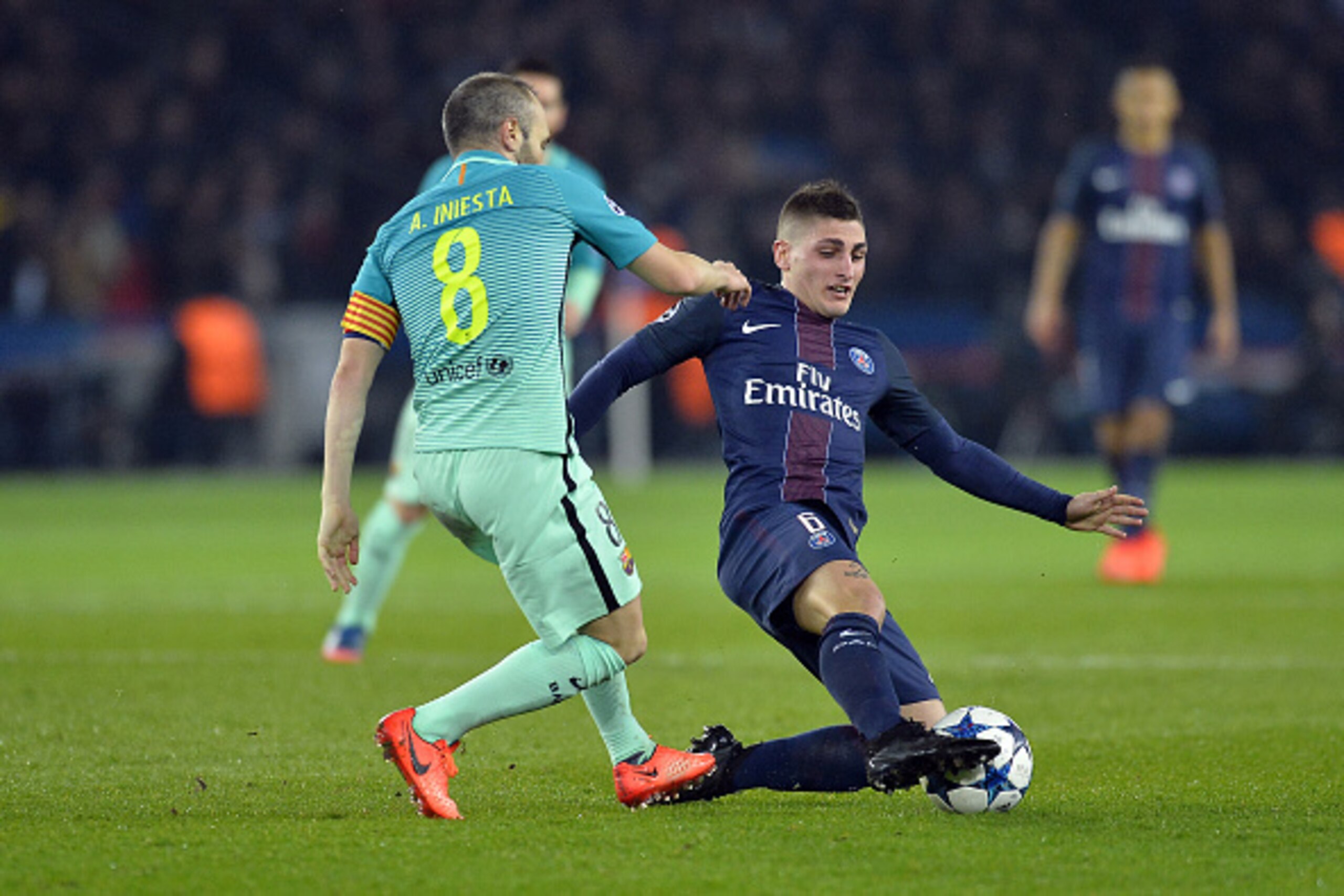 PARIS, FRANCE - FEBRUARY 14: Andres Iniesta of FC Barcelona and Marco Verratti of Paris-Saint Germain fight for the ball during the UEFA Champions League Round of 16 first leg match between Paris Saint-Germain and FC Barcelona at Parc des Princes on Febr PARIS, FRANCE - FEBRUARY 14: Andres Iniesta of FC Barcelona and Marco Verratti of Paris-Saint Germain fight for the ball during the UEFA Champions League Round of 16 first leg match between Paris Saint-Germain and FC Barcelona at Parc des Princes on Febr