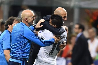 Real Madrid's Brazilian midfielder Casemiro (R) and Real Madrid's French coach Zinedine Zidane (2nd R) celebrate after Real Madrid won the UEFA Champions League final football match over Atletico Madrid at San Siro Stadium in Milan, on May 28, 2016.  / AF