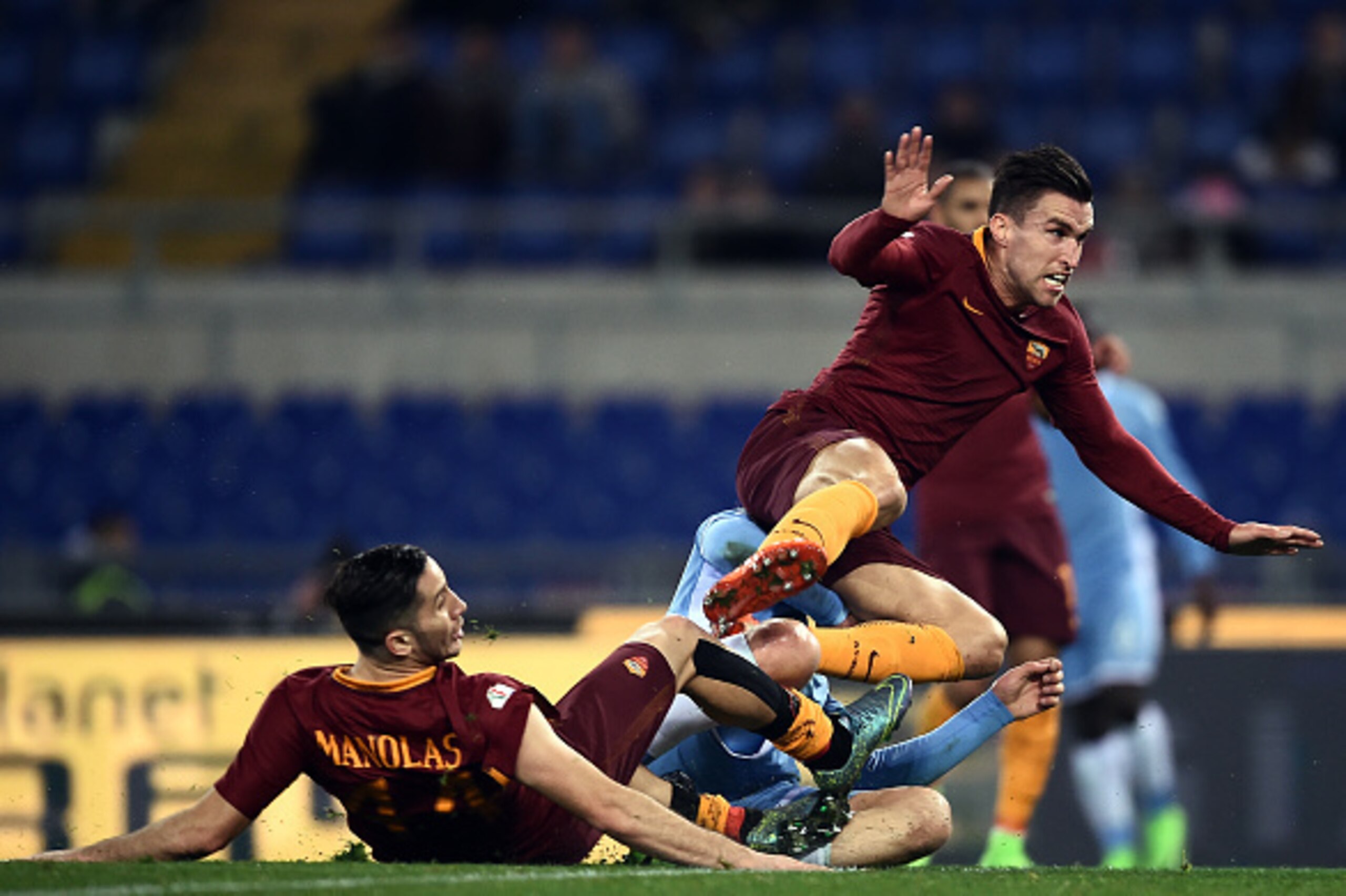 Roma's midfielder from Netherlands Kevin Strootman (top) reacts as Lazio midfielder form Croatia Sergej Milinkovic-Savic scores during the Italian TIM Cup 1st leg semifinal football match on March 1, 2017 at the Olympic stadium in Rome.  / AFP PHOTO / FIL