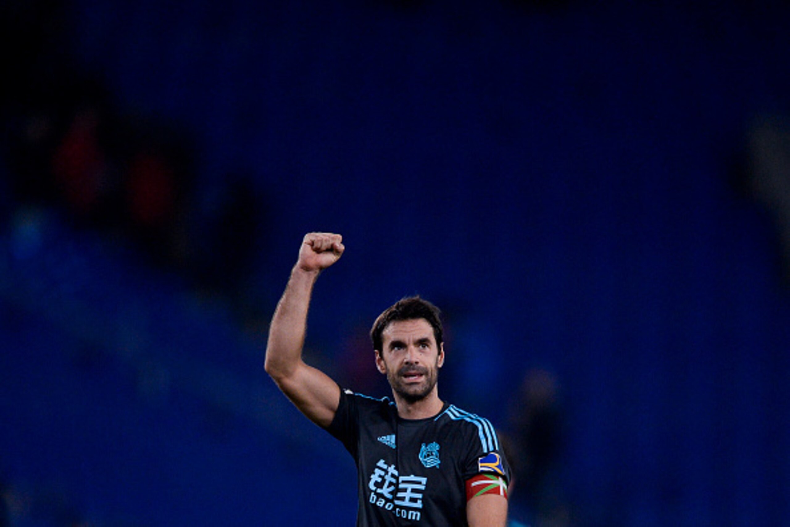 Real Sociedad's midfielder Xabi Prieto celebrates their victory at the end of the Spanish league football match RCD Espanyol vs Real Sociedad at the RCDE Stadium in Cornella de Llobregat on February 10, 2017. / AFP / Josep Lago        (Photo credit should