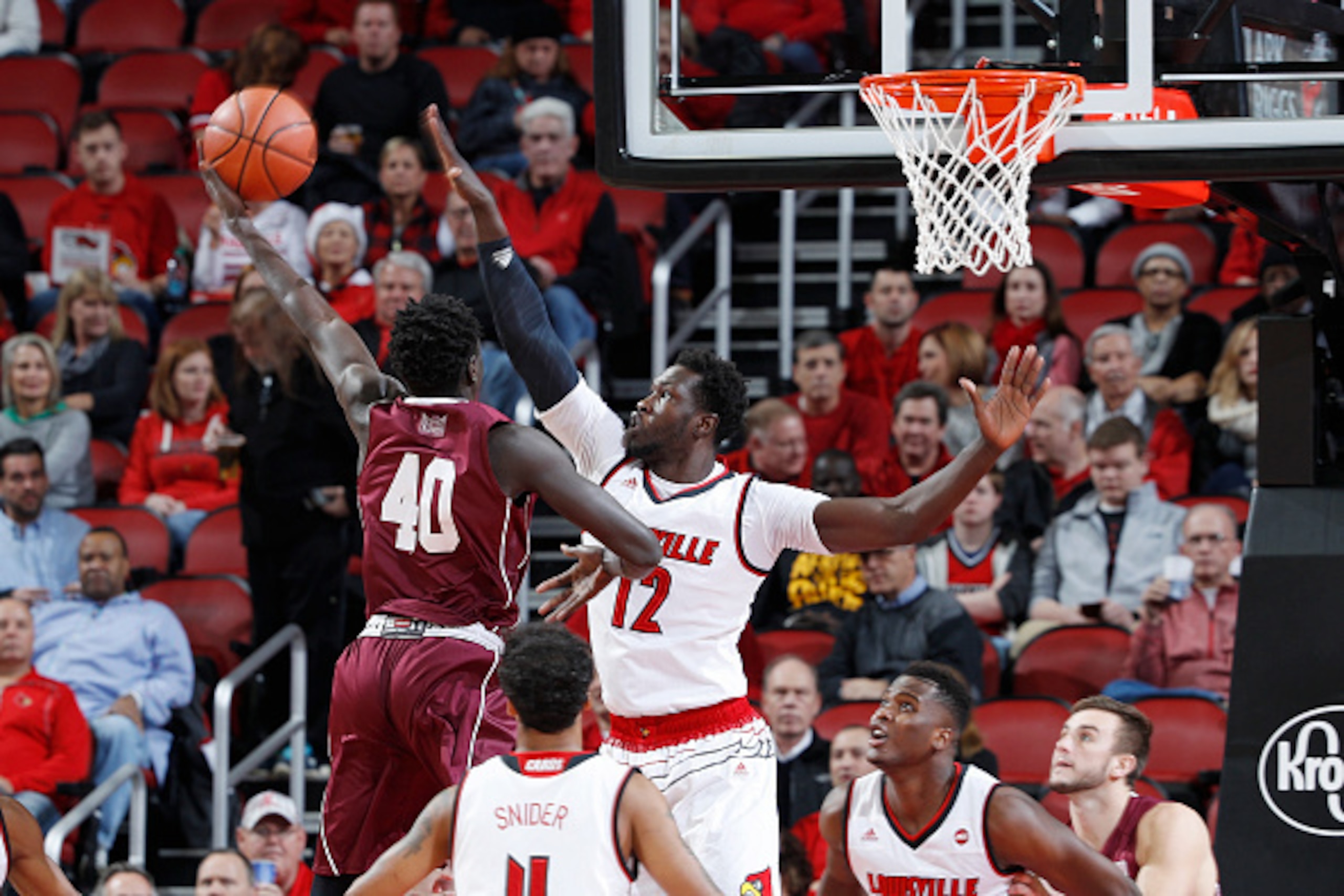 LOUISVILLE, KY - DECEMBER 07: Mangok Mathiang #12 of the Louisville Cardinals defends against Thik Bol #40 of the Southern Illinois Salukis in the first half of the game at KFC YUM! Center on December 7, 2016 in Louisville, Kentucky. (Photo by Joe Robbins