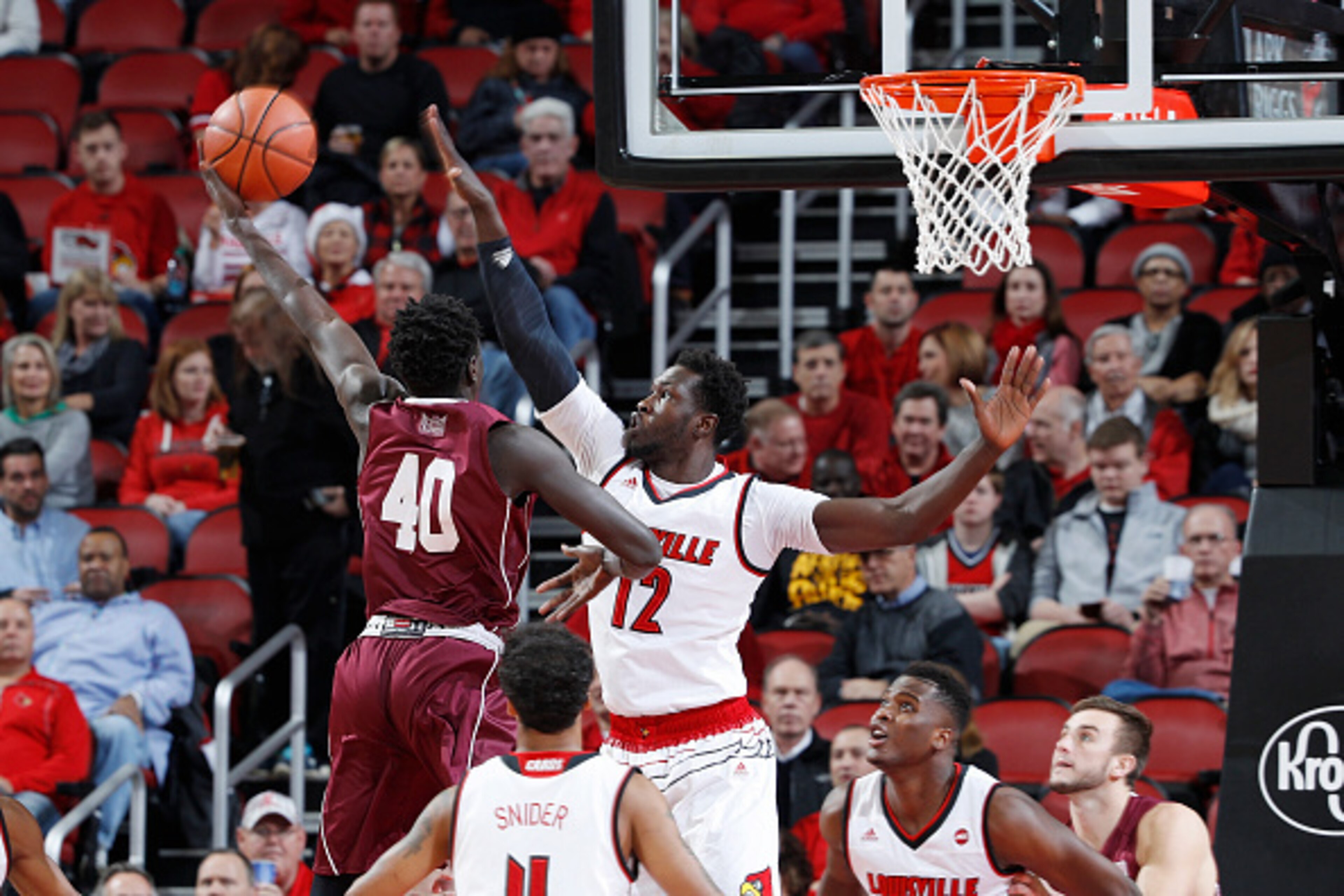 LOUISVILLE, KY - DECEMBER 07: Mangok Mathiang #12 of the Louisville Cardinals defends against Thik Bol #40 of the Southern Illinois Salukis in the first half of the game at KFC YUM! Center on December 7, 2016 in Louisville, Kentucky. (Photo by Joe Robbins
