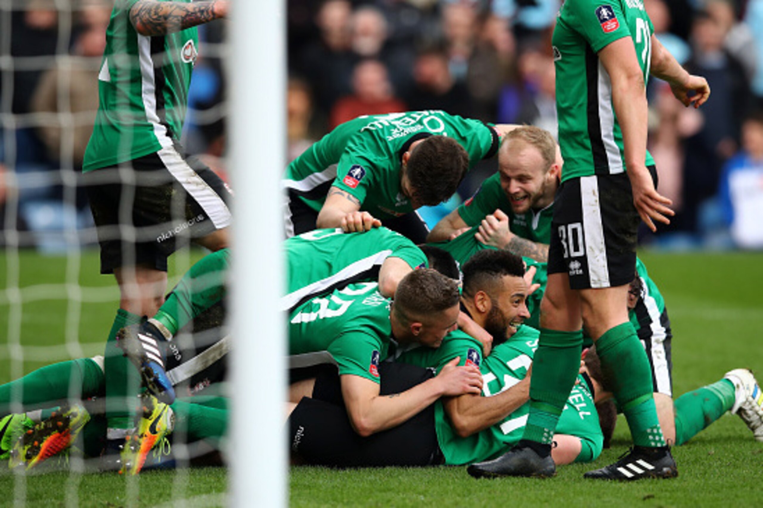 BURNLEY, ENGLAND - FEBRUARY 18:  Sean Raggett of Lincoln City (obscure) celebrates scoring his sides first goal with his Lincoln City team mates during The Emirates FA Cup Fifth Round match between Burnley and Lincoln City at Turf Moor on February 18, 201