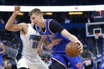 Mar 6, 2017; Orlando, FL, USA;  New York Knicks forward Kristaps Porzingis (6) drives around Orlando Magic forward Aaron Gordon (00) during the first quarter of an NBA basketball game at Amway Center. Mandatory Credit: Reinhold Matay-USA TODAY Sports