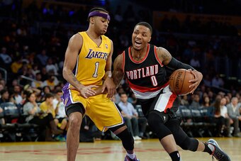 LOS ANGELES CA - OCTOBER 19: Damian Lillard #0 of the Portland Trail Blazers drives against D'Angelo Russell #1 of the Los Angeles Lakers during the first quarter of the basketball game at Staples Center October 19, 2015 in Los Angeles, California. NOTE T