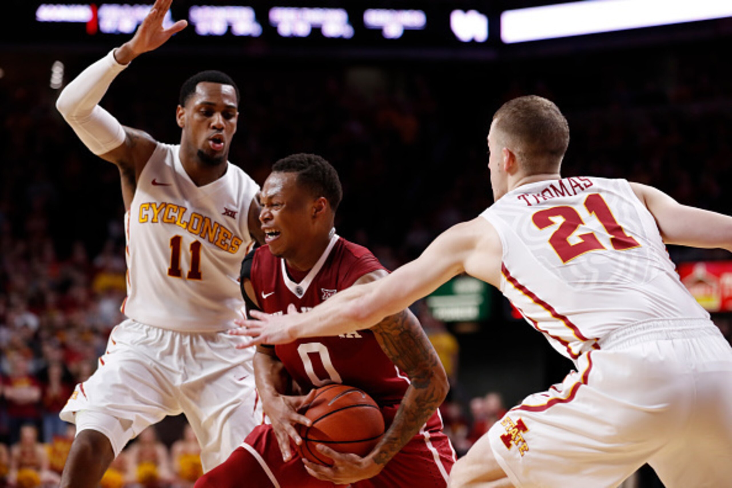 AMES, IA - FEBRUARY 11: Darrion Strong-Moore #0 of the Oklahoma Sooners drives the ball as Monte Morris #11, and Matt Thomas #21 of the Iowa State Cyclones put pressure on in the second half of play at Hilton Coliseum on February 11, 2017 in Ames, Iowa. T
