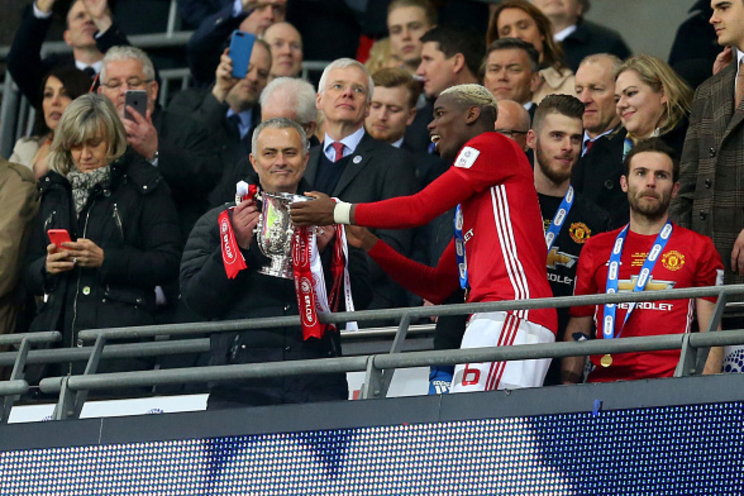 LONDON, ENGLAND - FEBRUARY 26: Paul Pogba of Manchester United hands the trophy to Jose Mourinho Manager of Manchester United during the EFL Cup Final match between Manchester United and Southampton at Wembley Stadium on February 26, 2017 in London, Engla