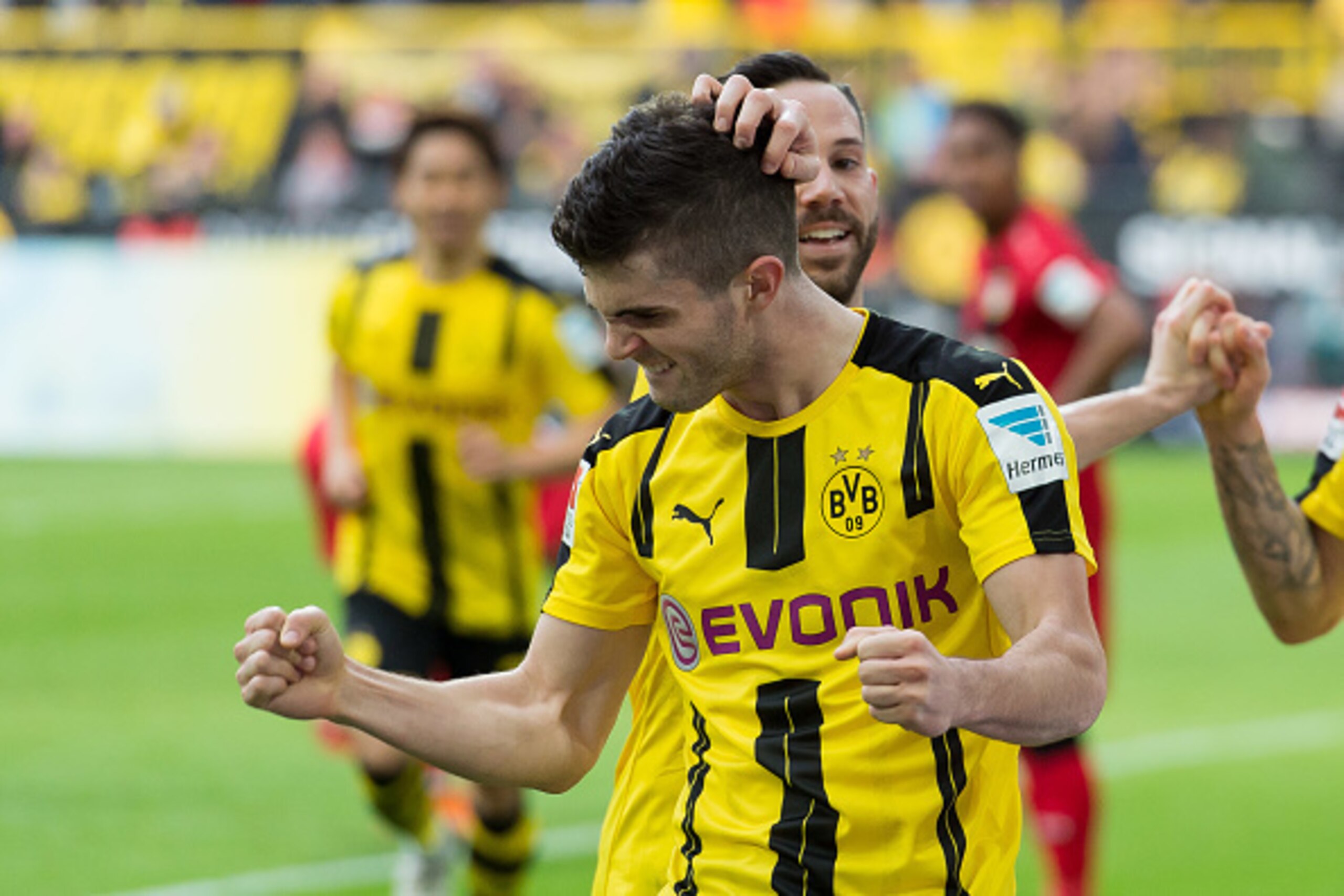 DORTMUND, GERMANY - MARCH 04: Christian Pulisic of Dortmund celebrates after scoring his teams fourth goal during the Bundesliga match between Borussia Dortmund and Bayer 04 Leverkusen at Signal Iduna Park on March 4, 2017 in Dortmund, Germany. (Photo by 