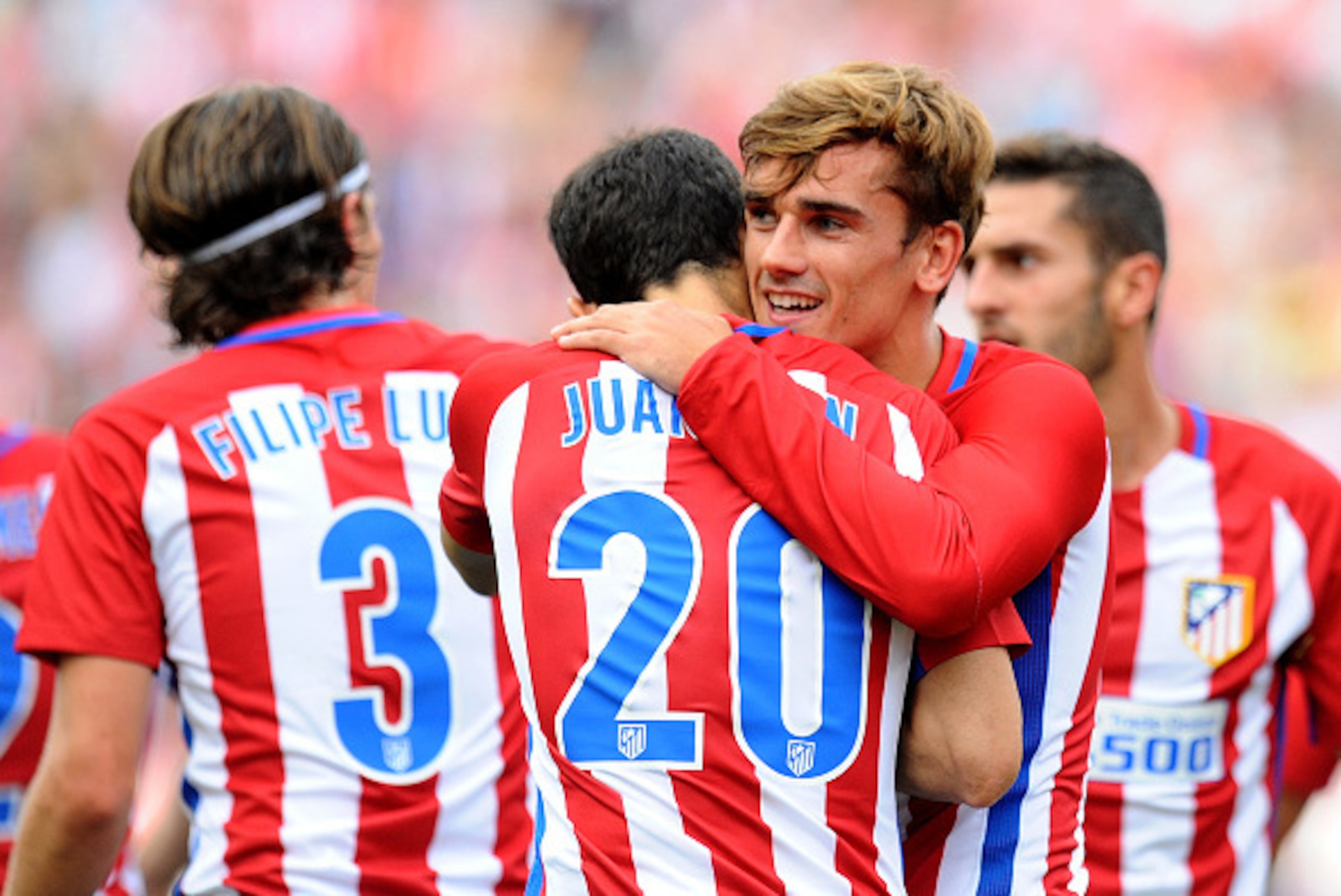 MADRID, SPAIN - SEPTEMBER 25: Antoine Greizmann of Club Atletico de Madrid celebrates with Juanfran after scoring his team's opening goal during the La Liga match between Atletico Madrid and Deportivo La Coruna at Vincente Calderon stadium on September 2 MADRID, SPAIN - SEPTEMBER 25: Antoine Greizmann of Club Atletico de Madrid celebrates with Juanfran after scoring his team's opening goal during the La Liga match between Atletico Madrid and Deportivo La Coruna at Vincente Calderon stadium on September 2