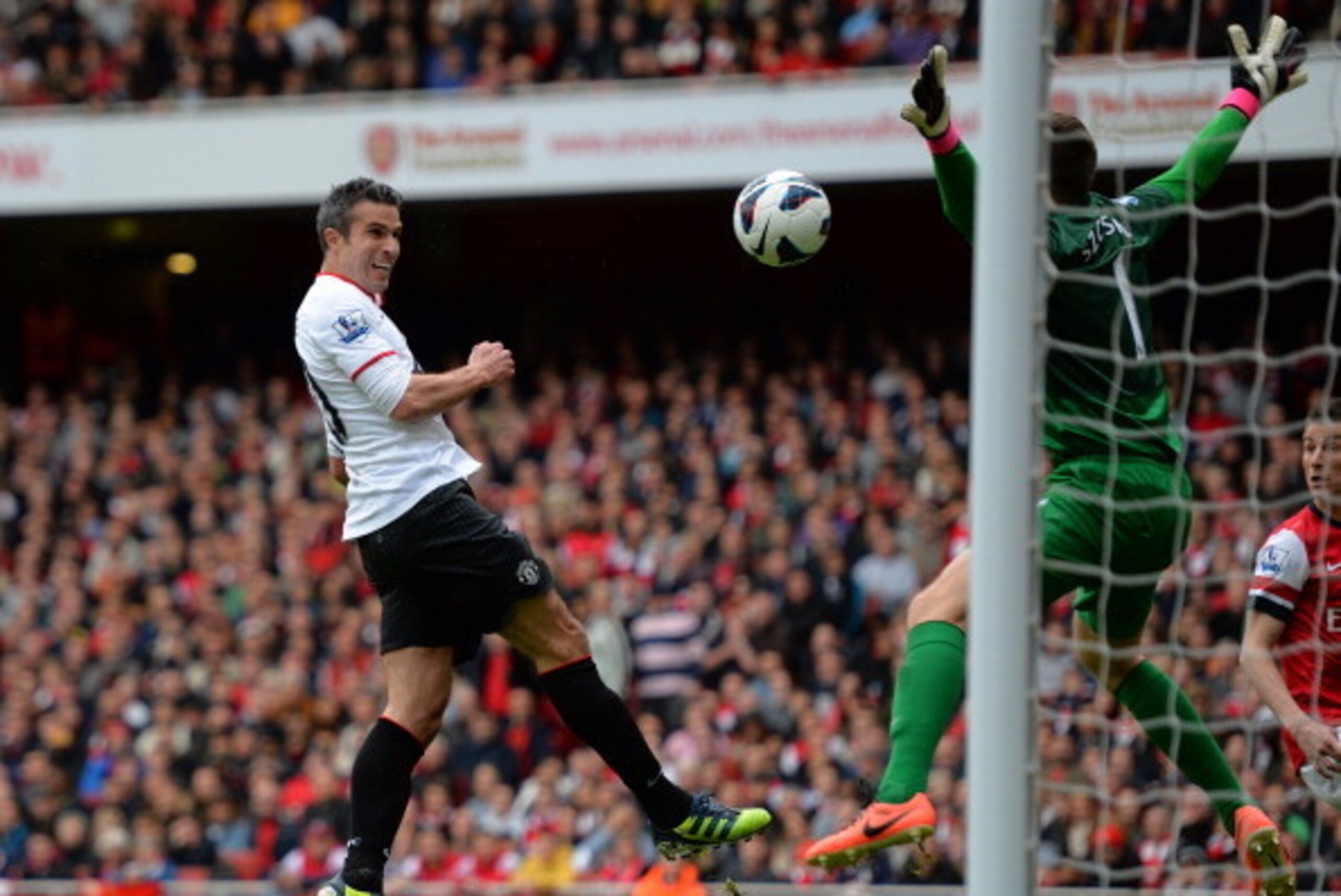 LONDON, ENGLAND - APRIL 28:  Robin van Persie of Manchester United has a close range header on goal saved by Wojciech Szczesny of Arsenal during the Barclays Premier League match between Arsenal and Manchester United at Emirates Stadium on April 28, 2013 