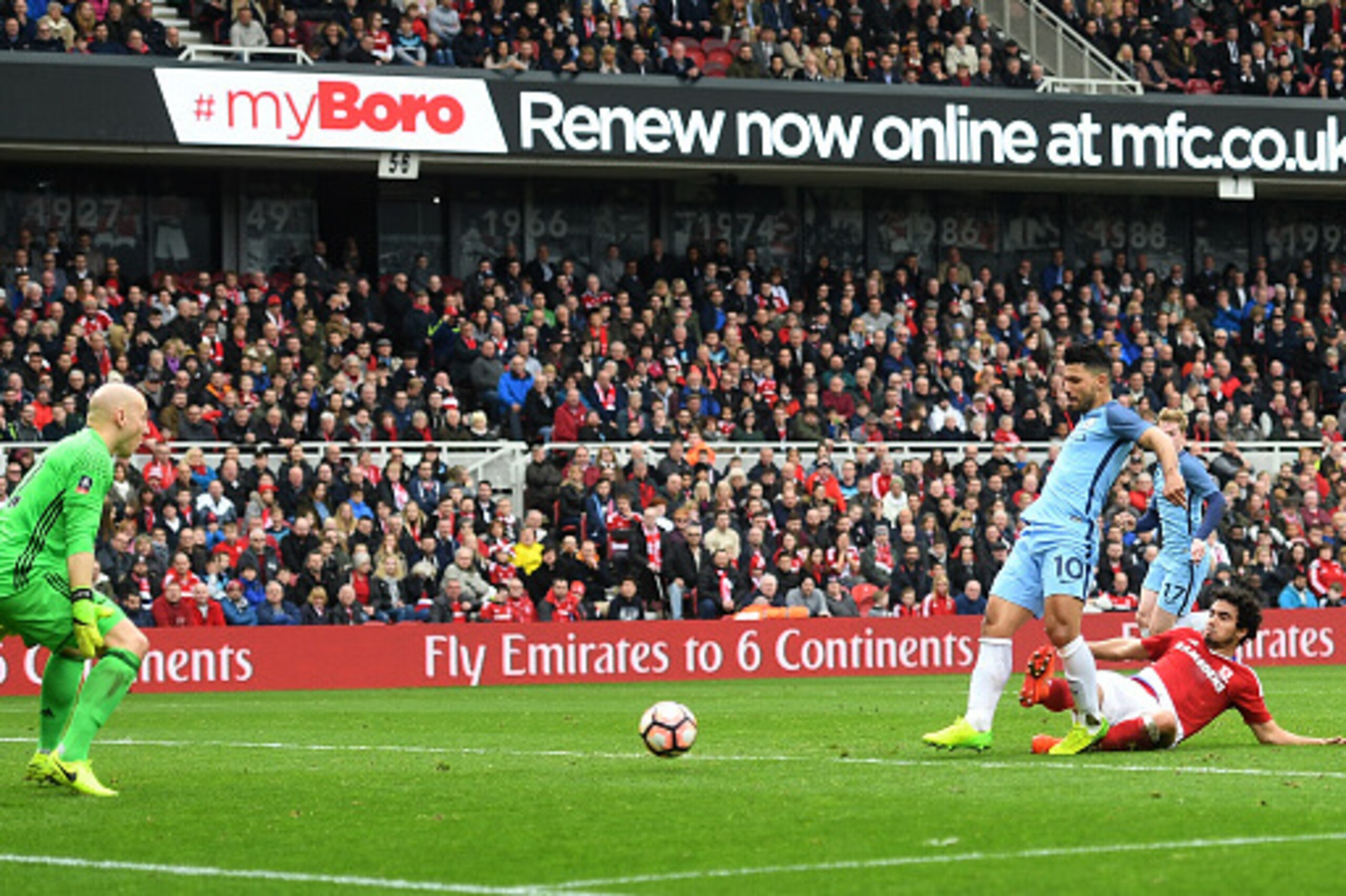 MIDDLESBROUGH, ENGLAND - MARCH 11: Sergio Aguero of Manchester City (R) scores his sides second goal past Brad Guzan of Middlesbrough (L) during The Emirates FA Cup Quarter-Final match between Middlesbrough and Manchester City at Riverside Stadium on Marc MIDDLESBROUGH, ENGLAND - MARCH 11: Sergio Aguero of Manchester City (R) scores his sides second goal past Brad Guzan of Middlesbrough (L) during The Emirates FA Cup Quarter-Final match between Middlesbrough and Manchester City at Riverside Stadium on Marc