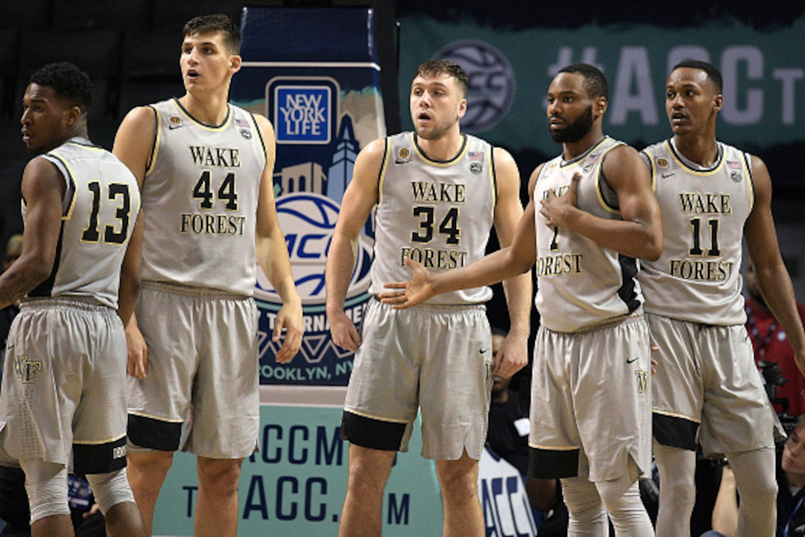 NEW YORK, NY - MARCH 07: Bryant Crawford #13, Konstantinos Mitoglou #44, Austin Arians #34, Keyshawn Woods #1 and Greg McClinton #11 of the Wake Forest Demon Deacons look on during their game against the Boston College Eagles during the first round of the
