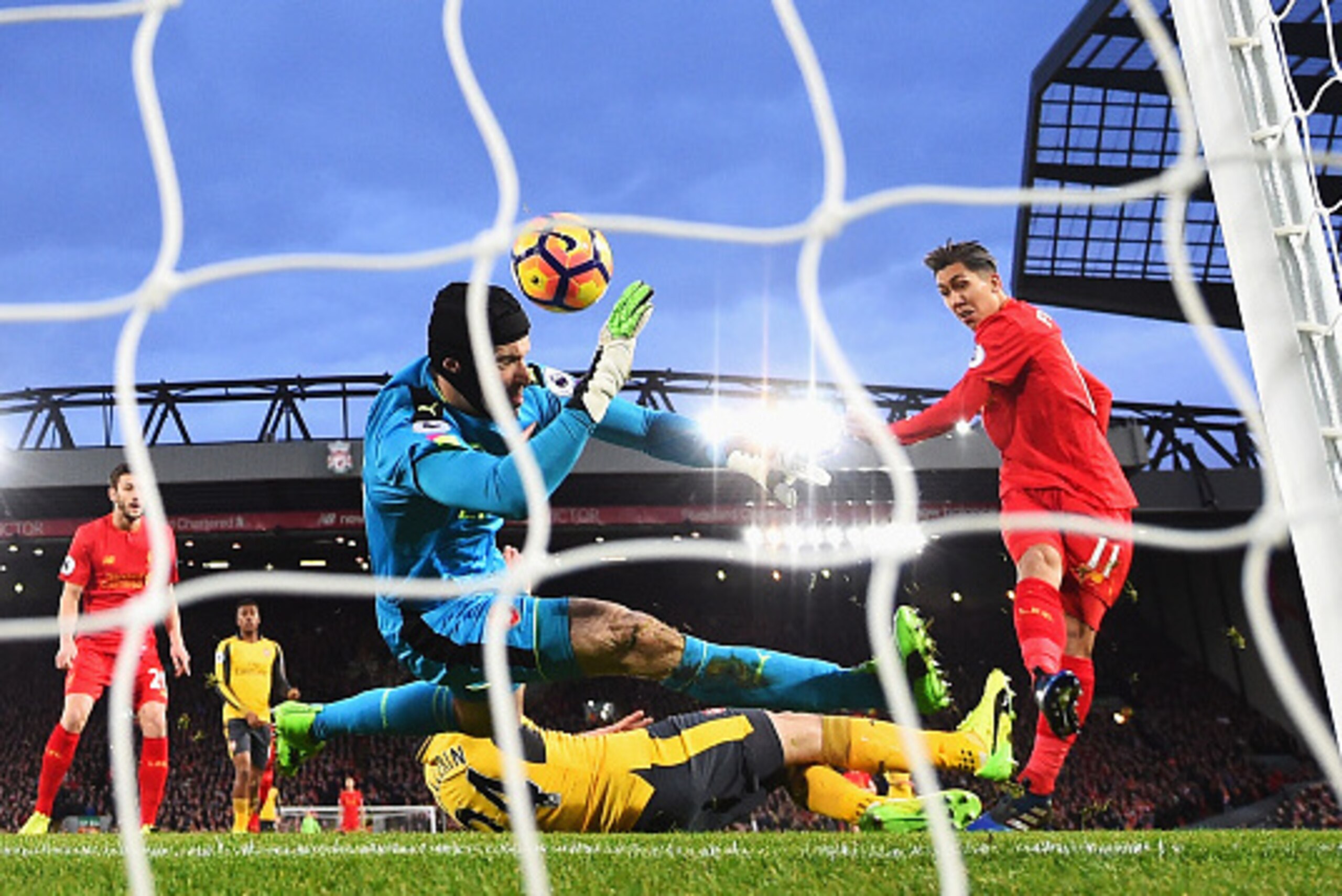 LIVERPOOL, ENGLAND - MARCH 04: Roberto Firmino of Liverpool (R) scores his sides first goal past Petr Cech of Arsenal (L) during the Premier League match between Liverpool and Arsenal at Anfield on March 4, 2017 in Liverpool, England.  (Photo by Laurence 