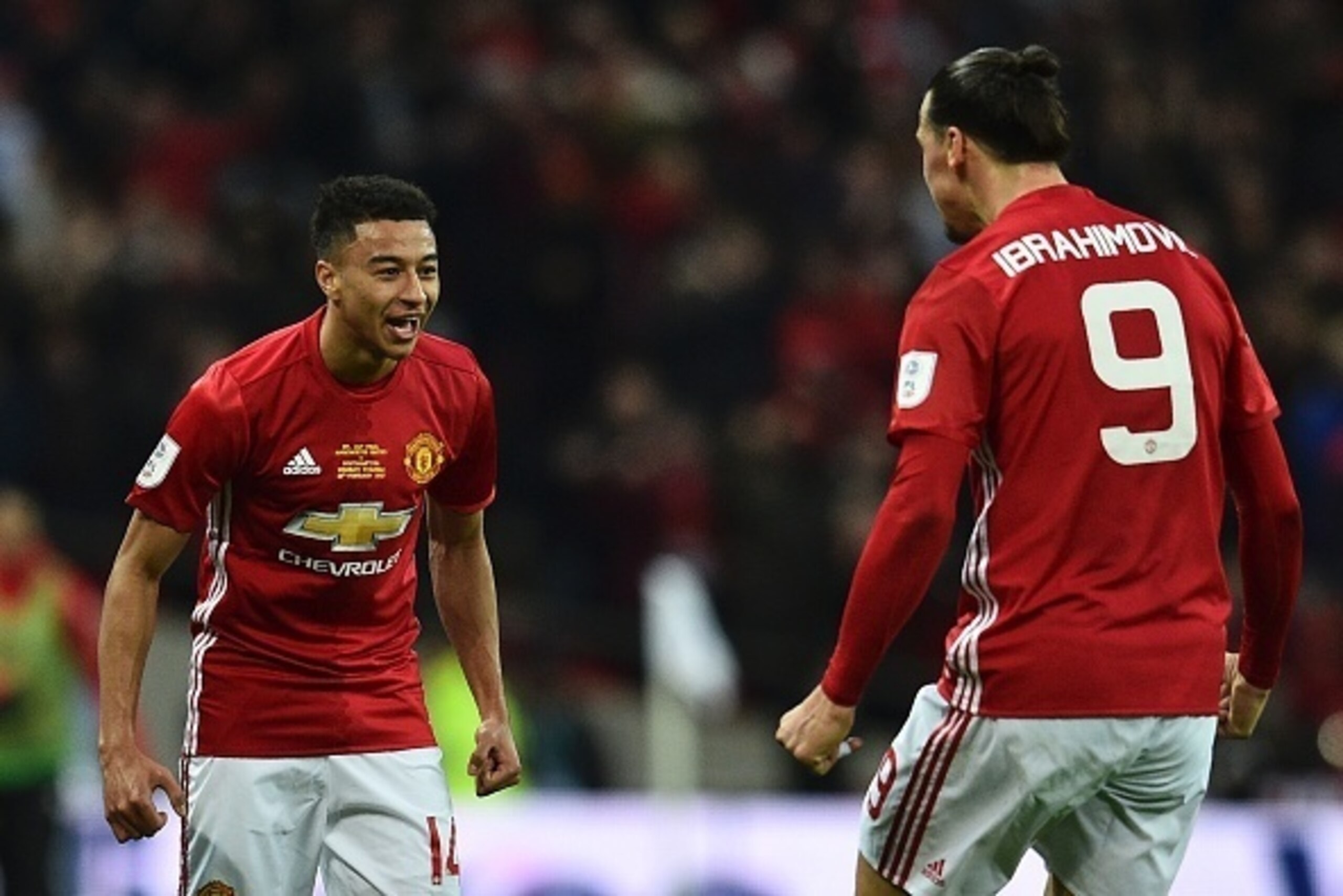 Manchester United's English midfielder Jesse Lingard (C) celebrates scoring their second goal with Manchester United's Swedish striker Zlatan Ibrahimovic (R) during the English League Cup final football match between Manchester United and Southampton at W