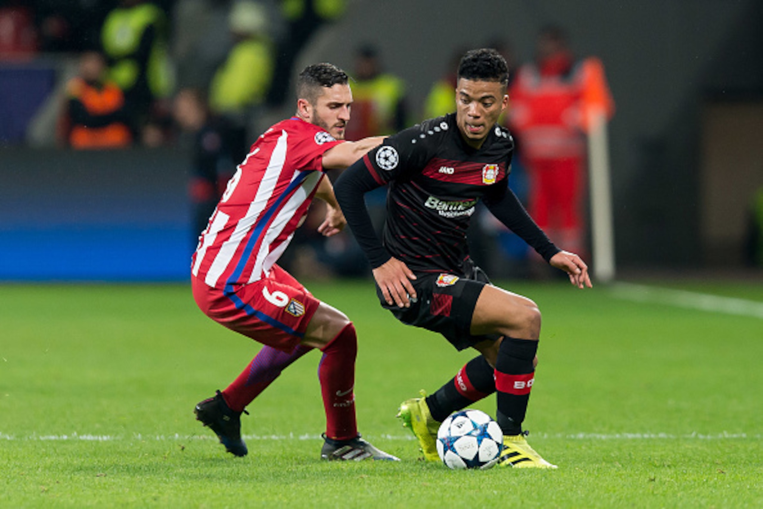 LEVERKUSEN, GERMANY - FEBRUARY 21: Koke of Atletico Madrid and Benjamin Henrichs of Bayer Leverkusen battle for the ball during the UEFA Champions League Round of 16 first leg match between Bayer Leverkusen and Club Atletico de Madrid at BayArena on Febru