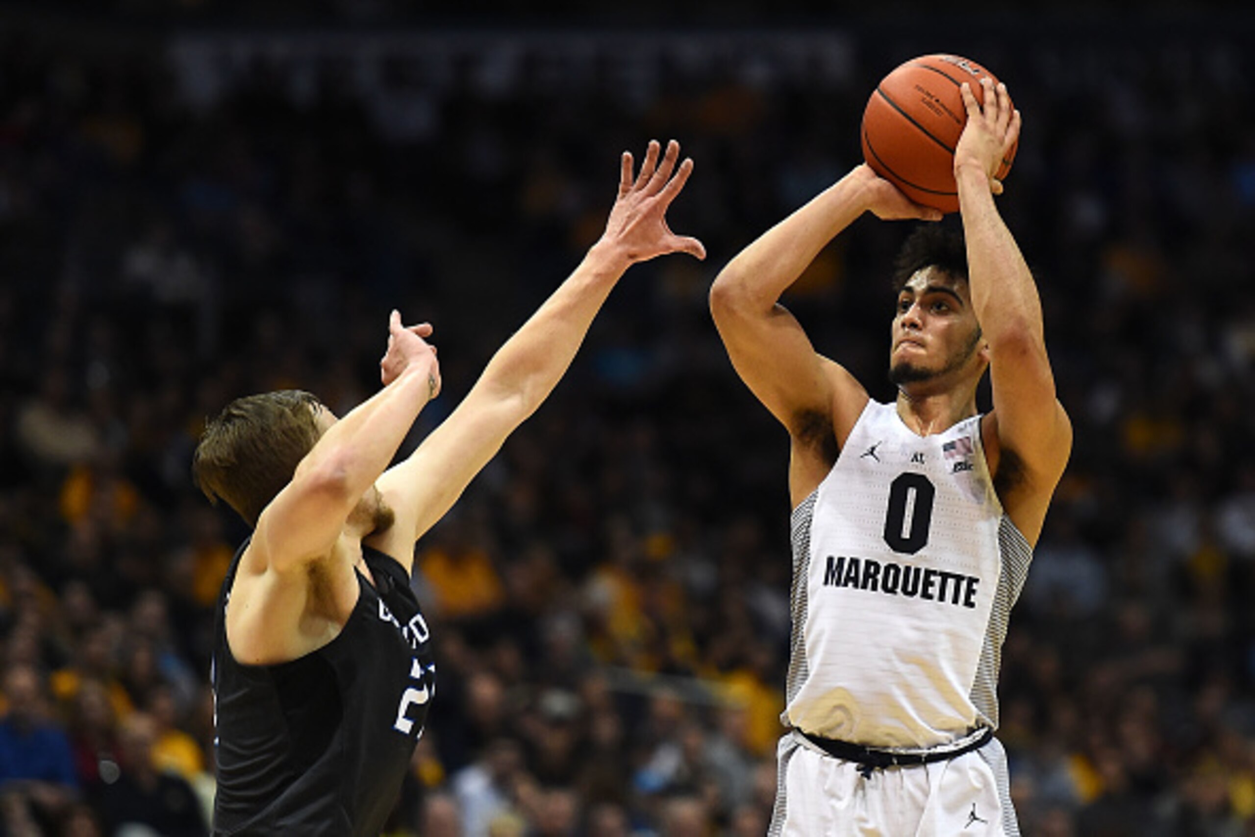 MILWAUKEE, WI - MARCH 04:  Markus Howard #0 of the Marquette Golden Eagles takes a three point shot over Isaiah Zierden #21 of the Creighton Bluejays during the second half of a game at the BMO Harris Bradley Center on March 4, 2017 in Milwaukee, Wisconsi
