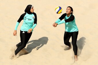RIO DE JANEIRO, BRAZIL - AUGUST 09: Doaa Elghobashy (L) and Nada Meawad of Egypt in action during the Women's Beach Volleyball Preliminary Pool A match against Marta Menegatti and Laura Giombini of Italy on Day 4 of the Rio 2016 Olympic Games at the Beach