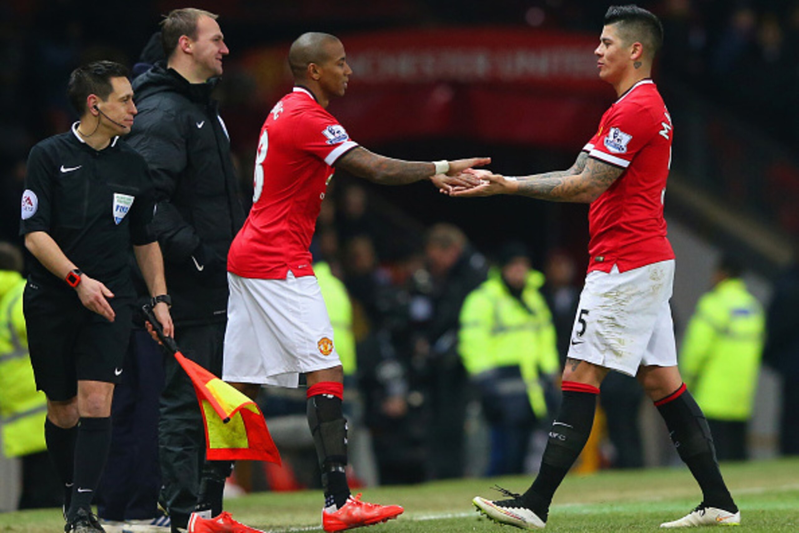MANCHESTER, ENGLAND - FEBRUARY 03: Ashley Young of Manchester United replaces Marcos Rojo of Manchester United  during the FA Cup Fourth round replay match between Manchester United and Cambridge United at Old Trafford on February 3, 2015 in Manchester, E