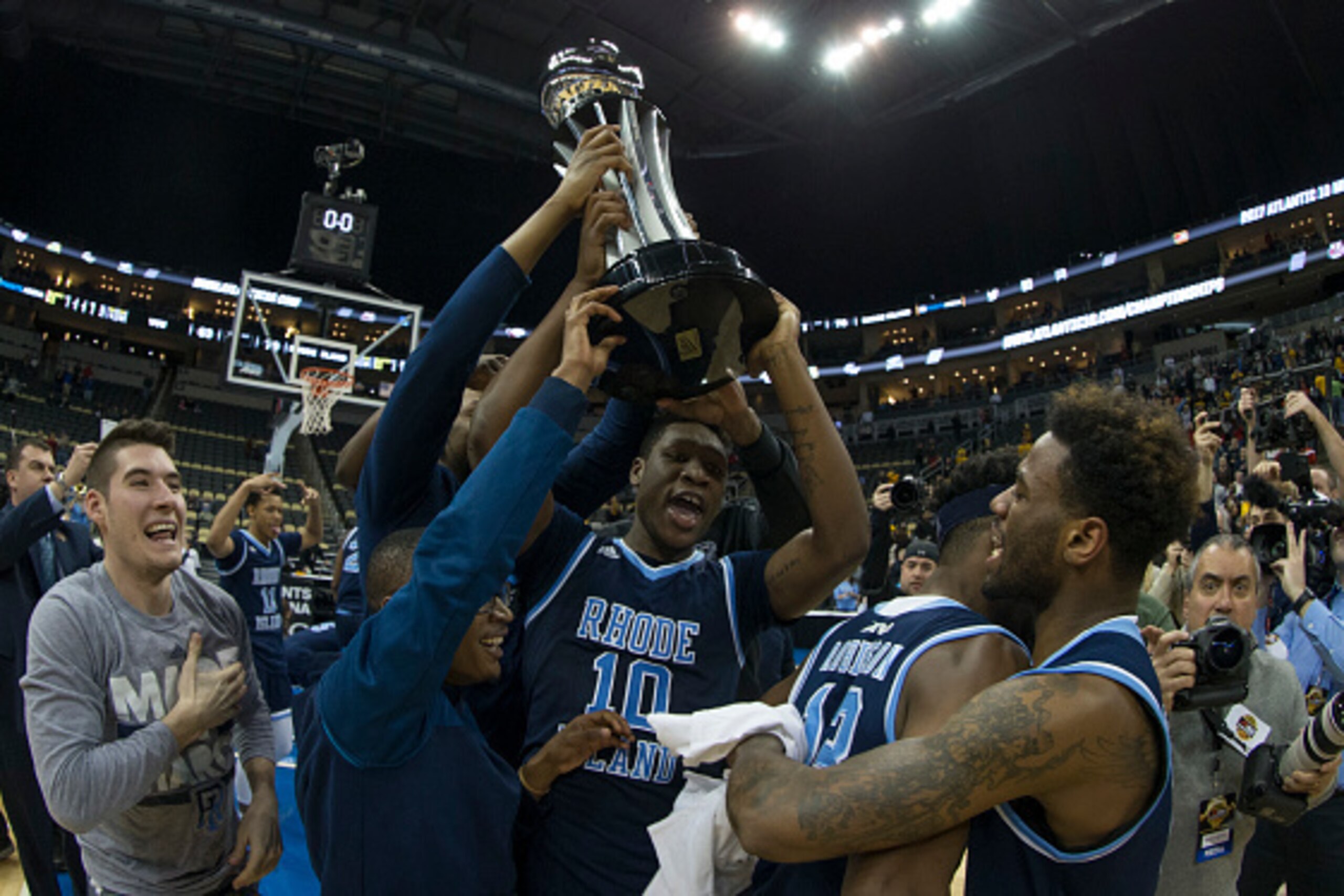 PITTSBURGH, PA - MARCH 12: Cyril Langevine #10 of the Rhode Island Rams holds up the trophy after the game against the Virginia Commonwealth Rams in the Championship game of the men's Atlantic 10 tournament at the PPG Paints Arena on March 12, 2017 in Pit