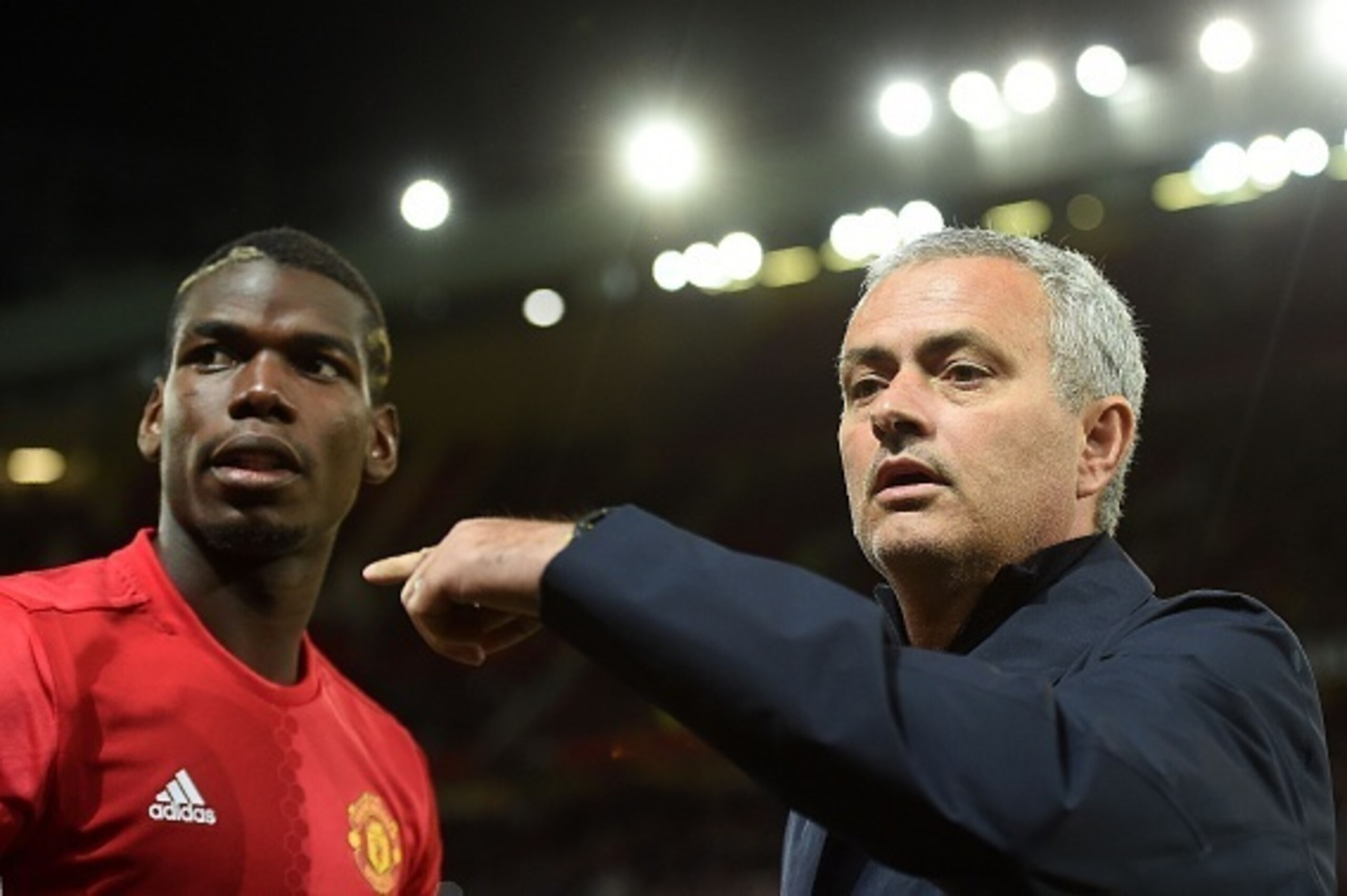 Manchester United's Portuguese manager Jose Mourinho (R) gestures to Manchester United's French midfielder Paul Pogba as he arrives on the pitch ahead of the UEFA Europa League group A football match between Manchester United and Zorya Luhansk at Old Traf Manchester United's Portuguese manager Jose Mourinho (R) gestures to Manchester United's French midfielder Paul Pogba as he arrives on the pitch ahead of the UEFA Europa League group A football match between Manchester United and Zorya Luhansk at Old Traf